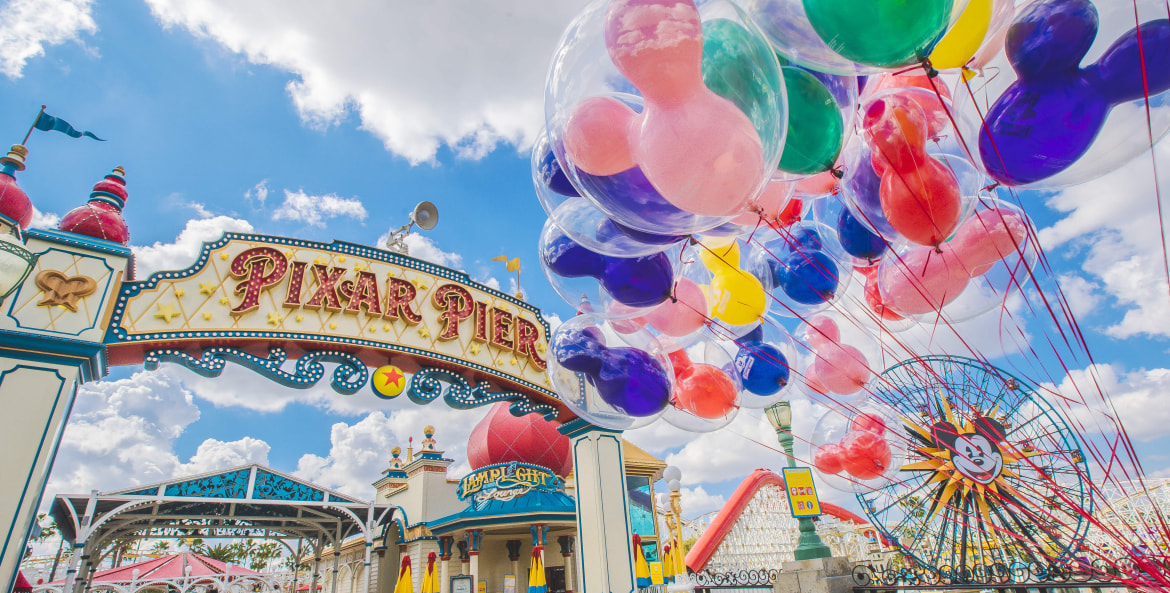 mickey mouse balloons float at the entrance to pixar pier at california adventure