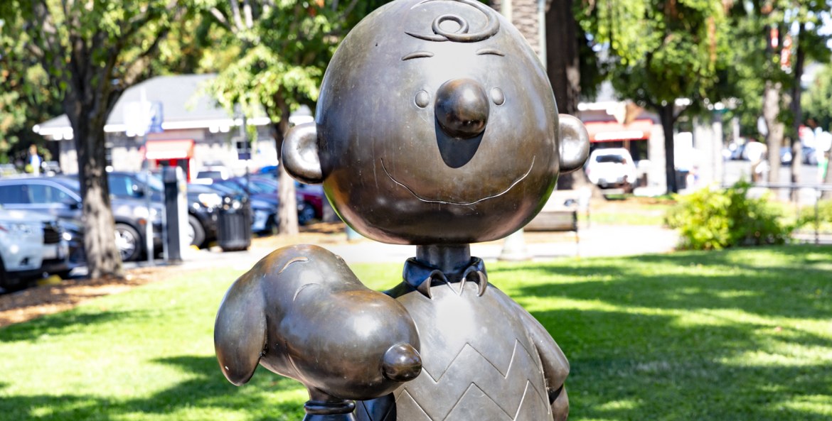 A lifesized bronze statue of Charlie Brown and Snoopy.