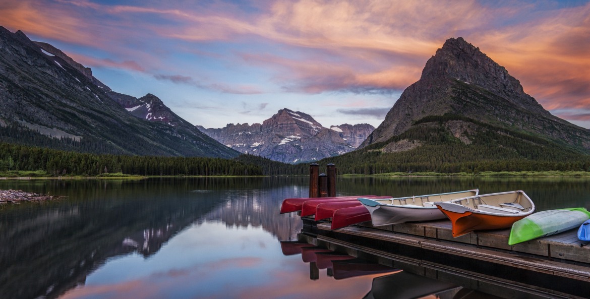 Canoes and row boats on the dock at Swiftcurrent Lake in Glacier National Park, Montana.