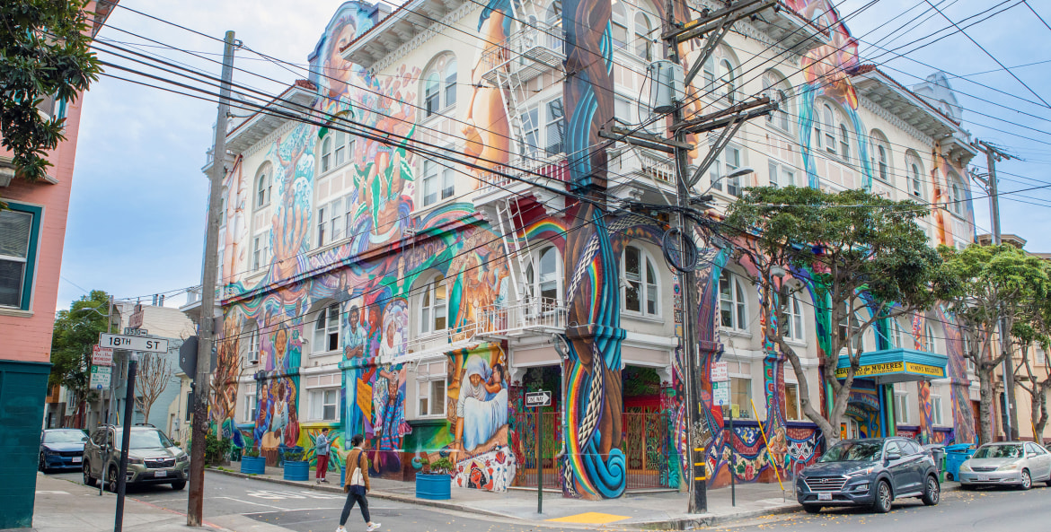 A mural covers the multi-story women's building in San Francisco's Mission District.