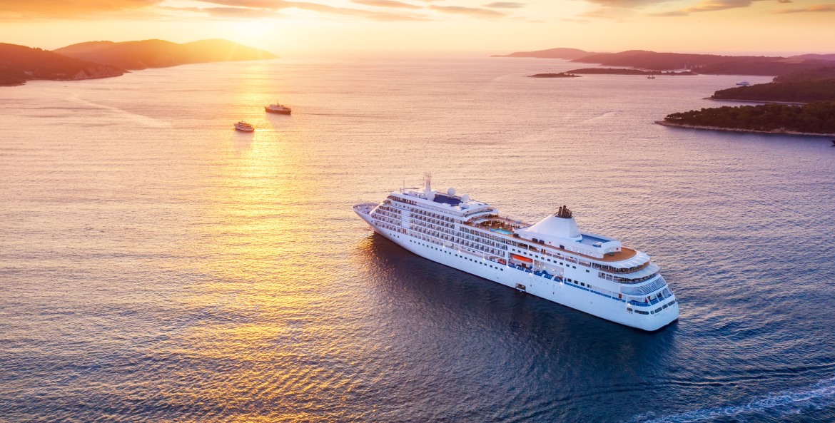 A cruise ship in the waters near Croatia at sunset.
