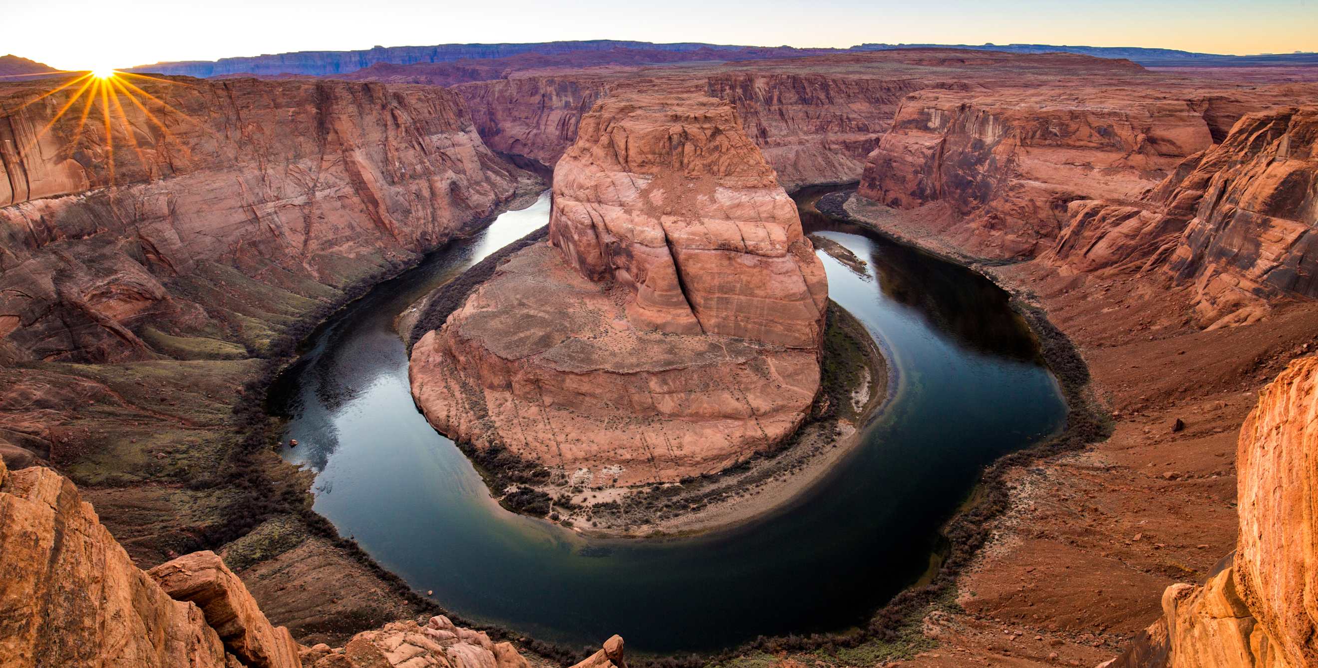 The sun sets behind Horsehoe Bend near Page, Arizona.
