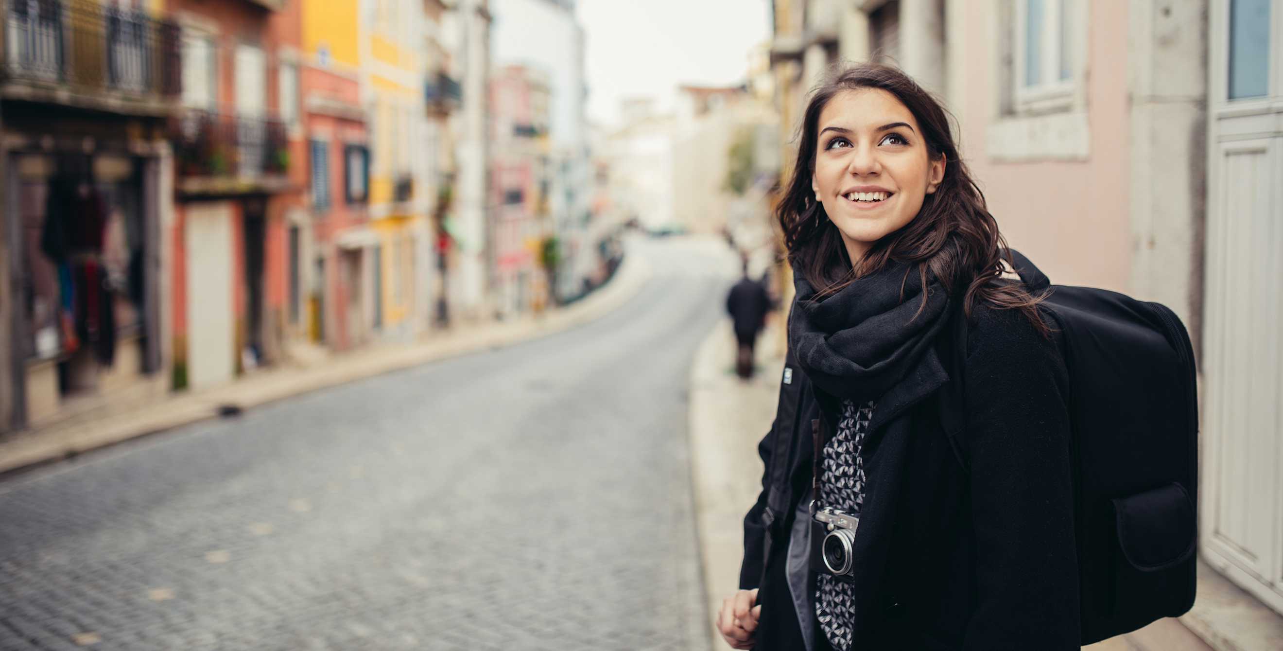 a woman smiling while she travels alone
