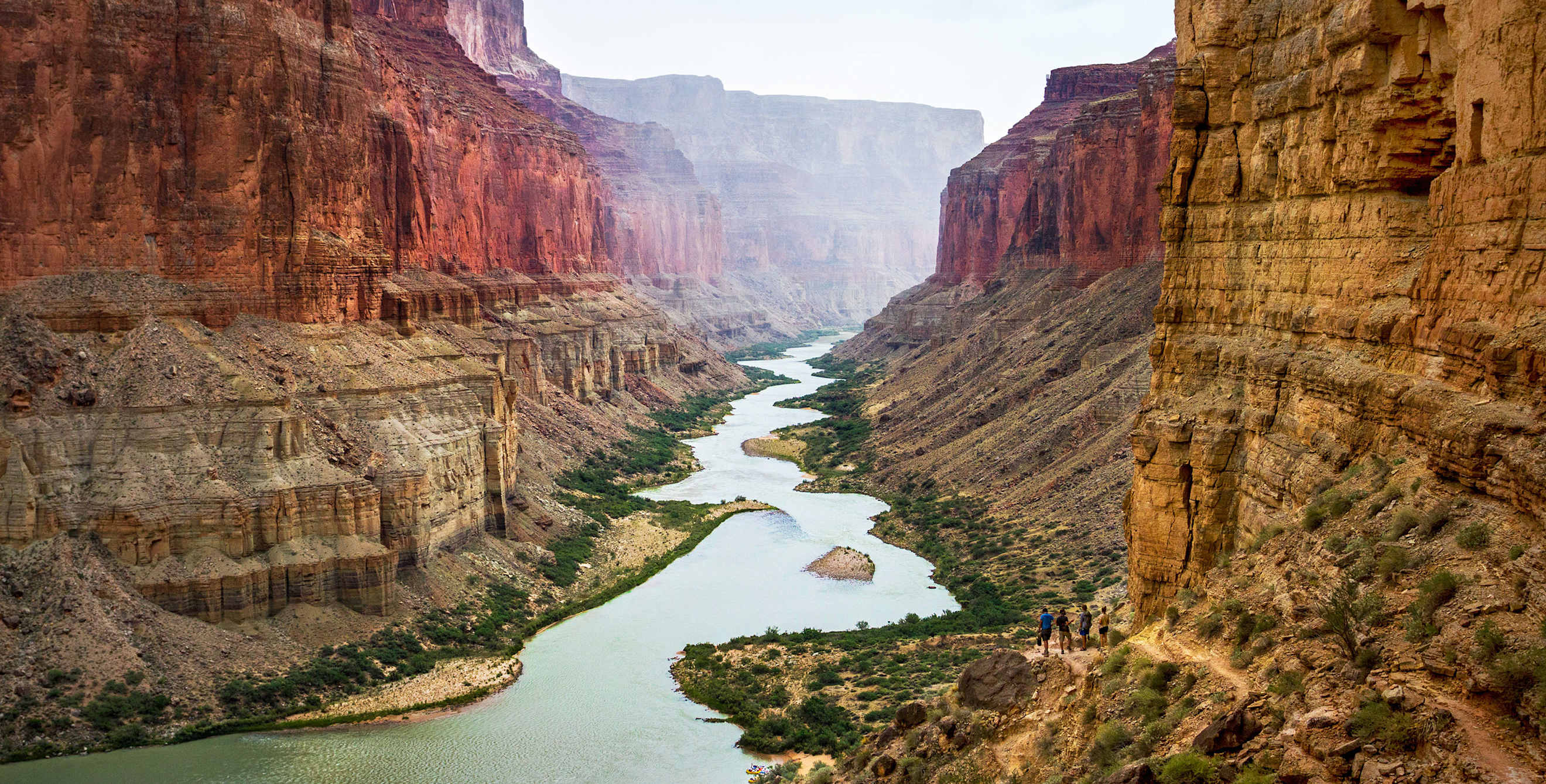 People hiking the Nankoweap Trail into the canyon at Grand Canyon National Park, image
