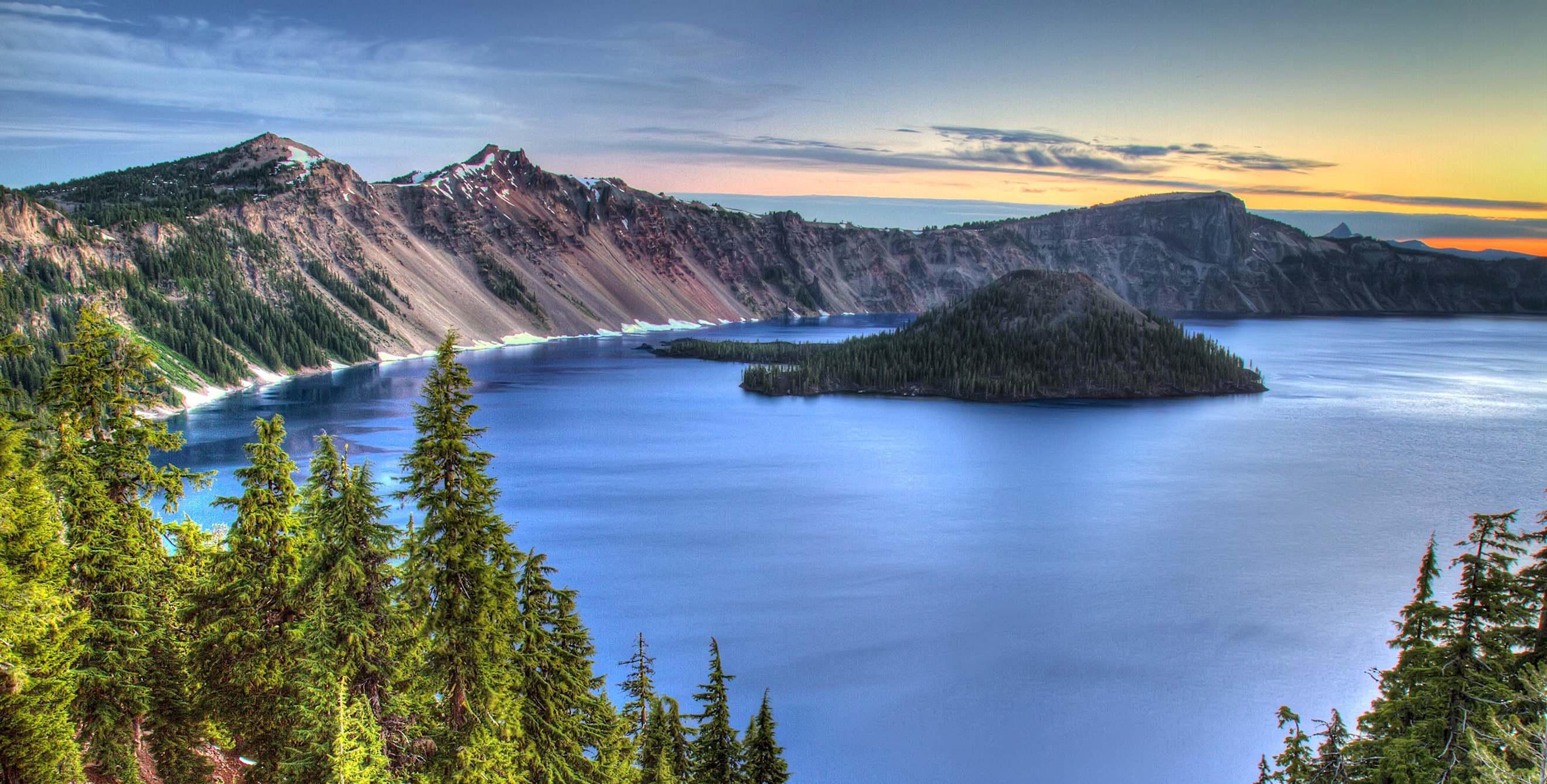 deep blue water of Crater Lake, Oregon at sunset
