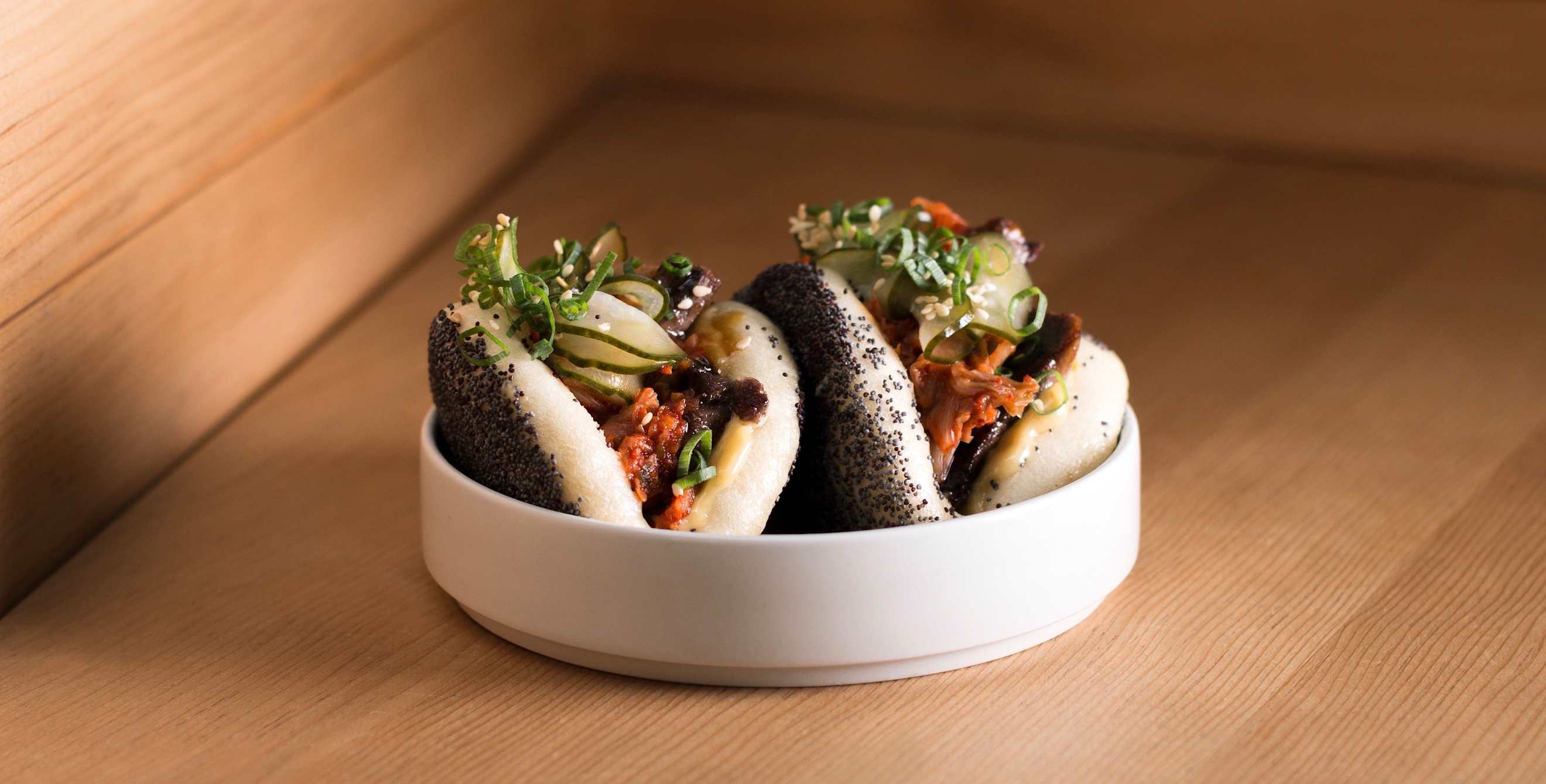 picture of the poppy seed covered steamed buns with beef tongue and kimchi at Liholiho Yacht Club
