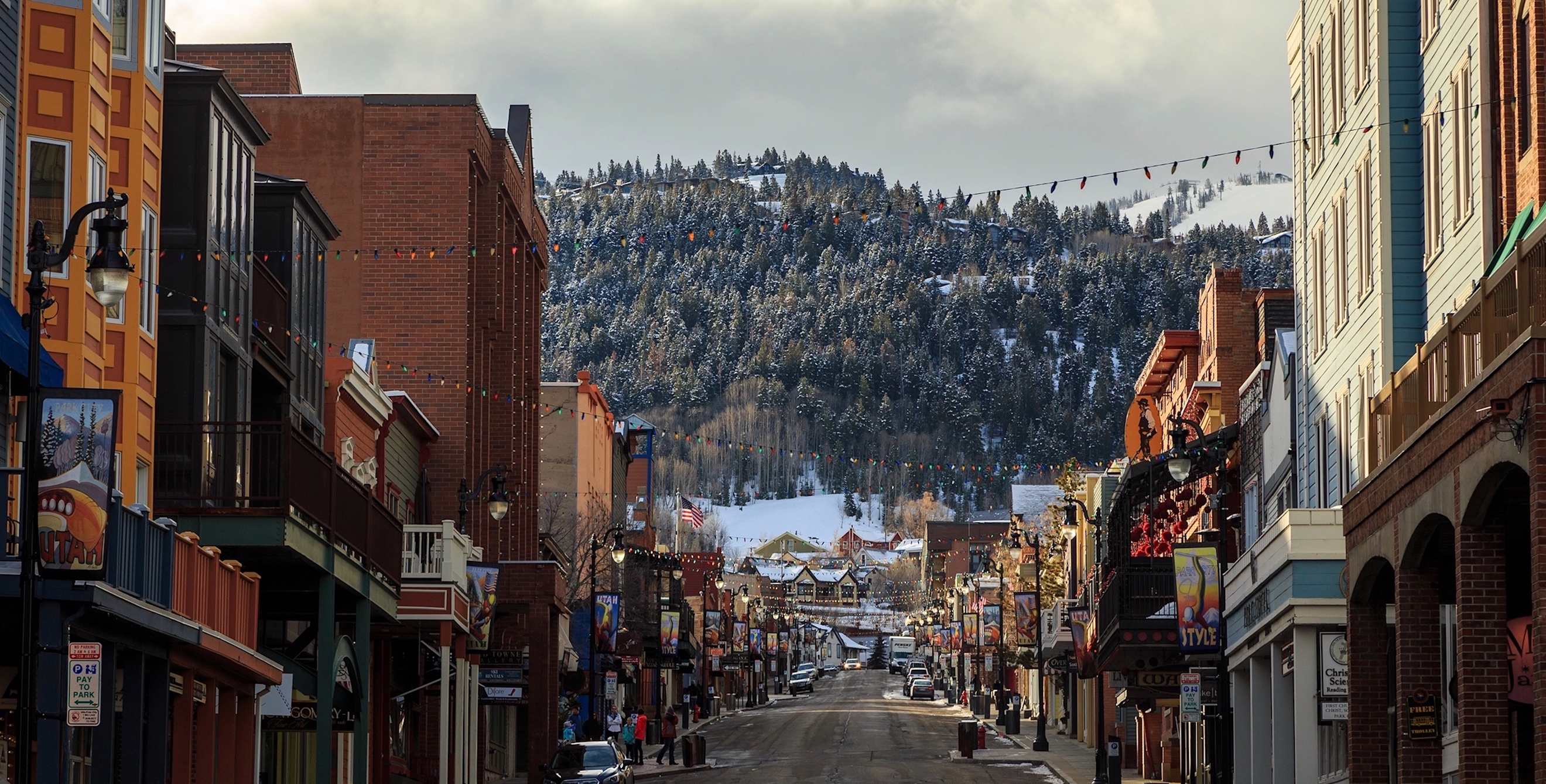 Main Street in Park City, Utah, looking towards the mountains with clouds in the sky