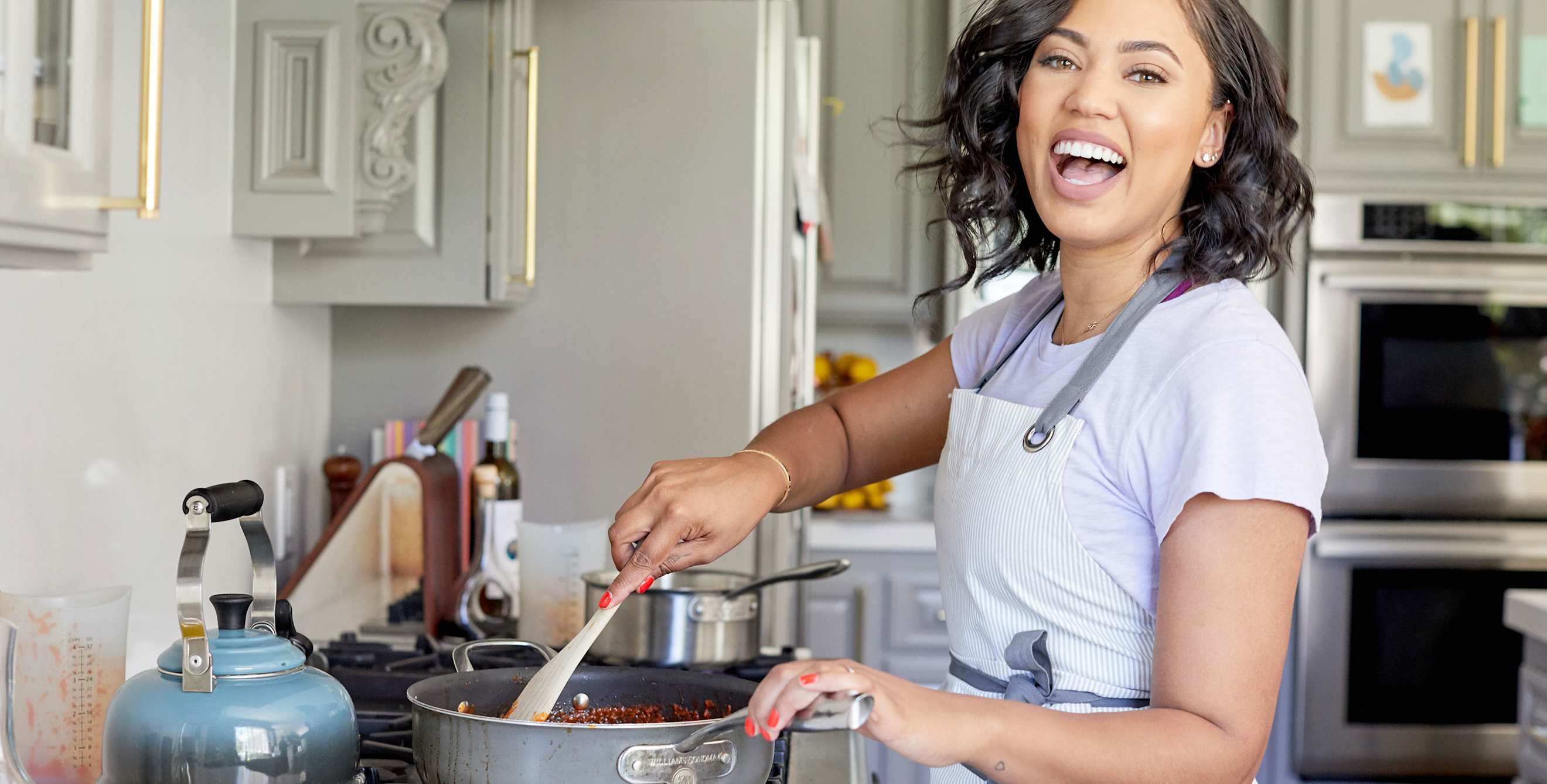 Ayesha Curry cooking in her home kitchen, image