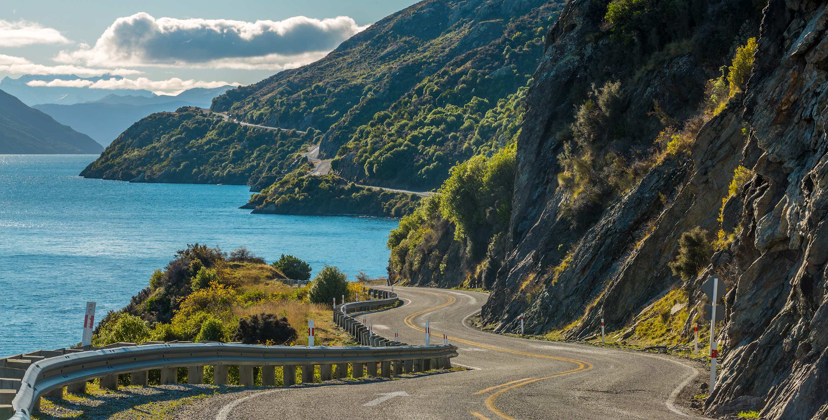 road curves along Lake Wakatipu near Queenstown, New Zealand