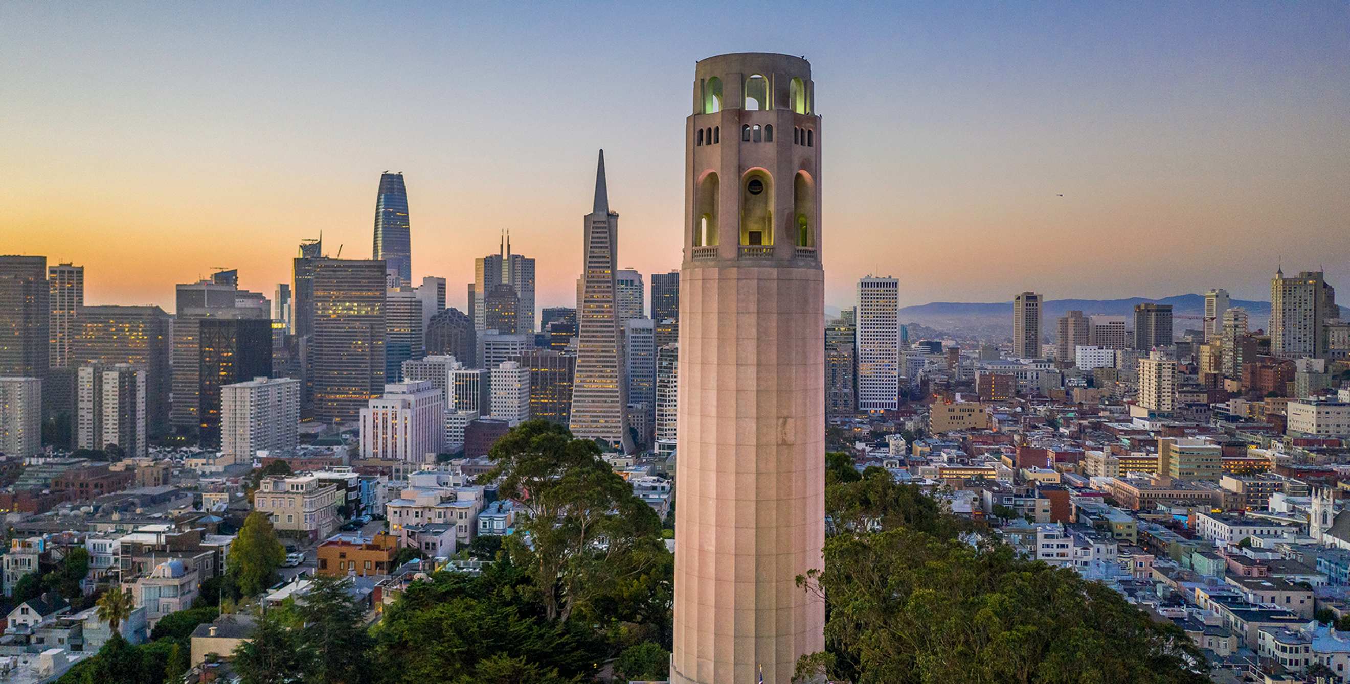 Coit Tower overlooks downtown San Francisco at dawn