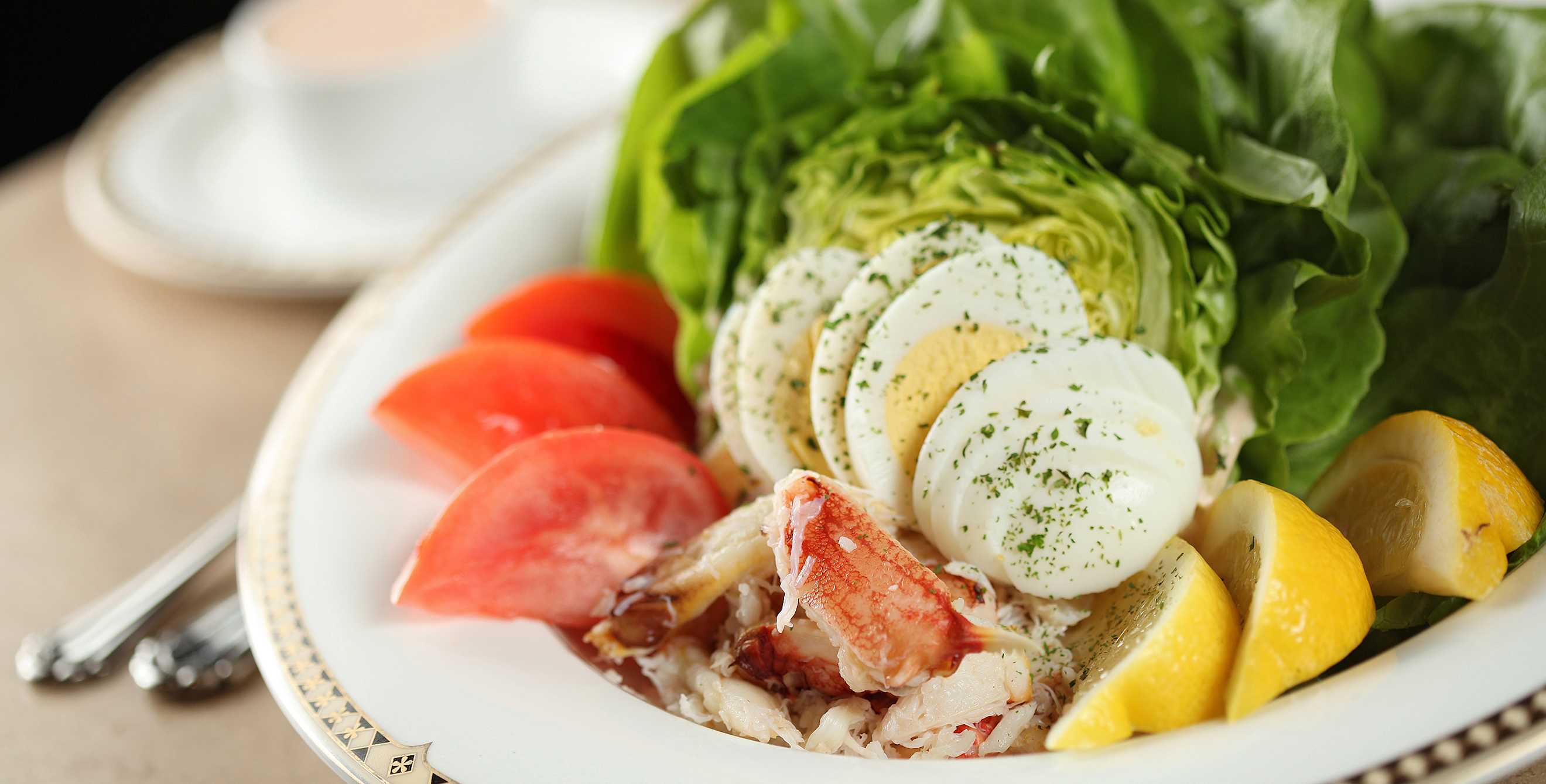 crab Louie salad with lump crab meat, tomato, lettuce, hardboiled egg, and lemon wedges at Palm Court Grill at The Historic Davenport Hotel in Spokane, Washington