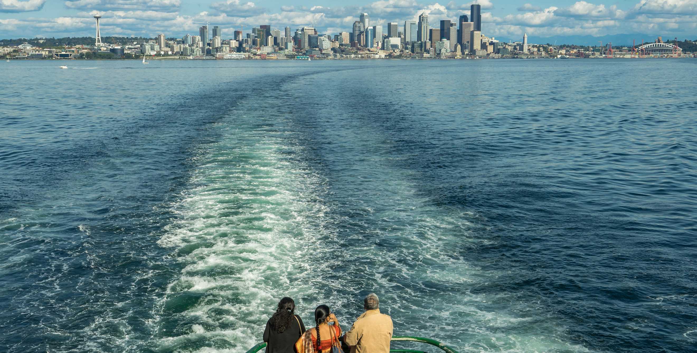 Bainbridge Island ferry passengers look out on the Seattle skyline views