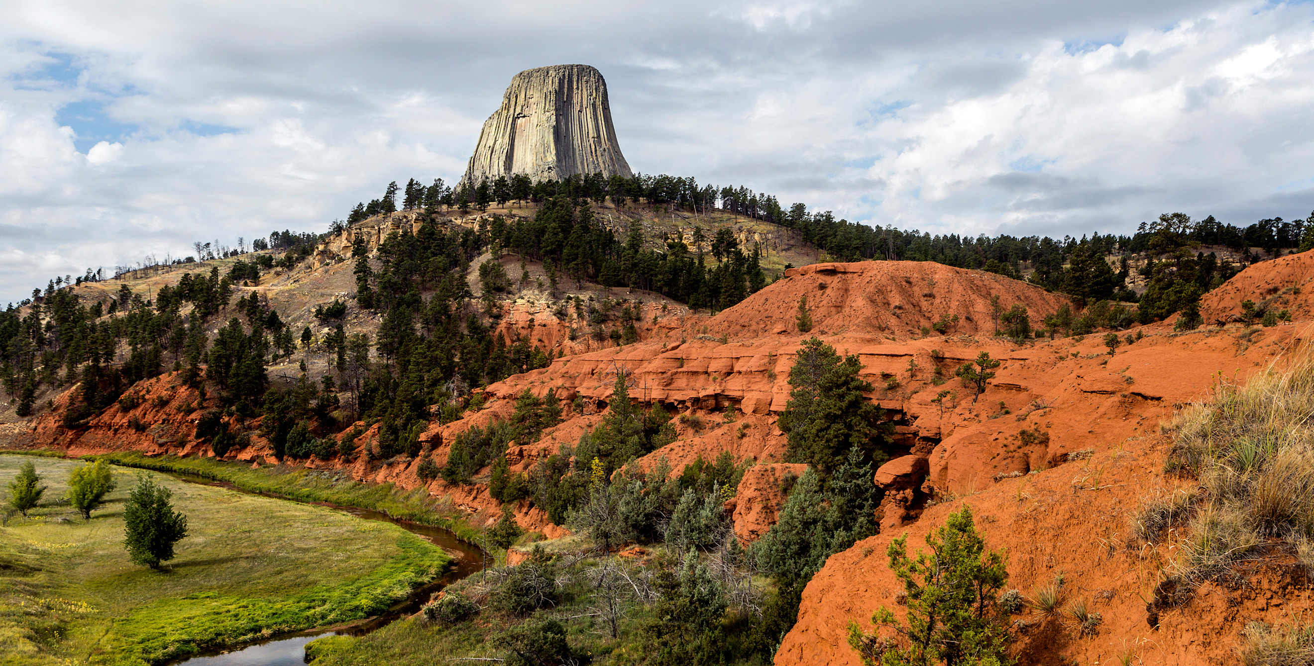 rock monolith looms over Devils Tower National Monument in Wyoming
