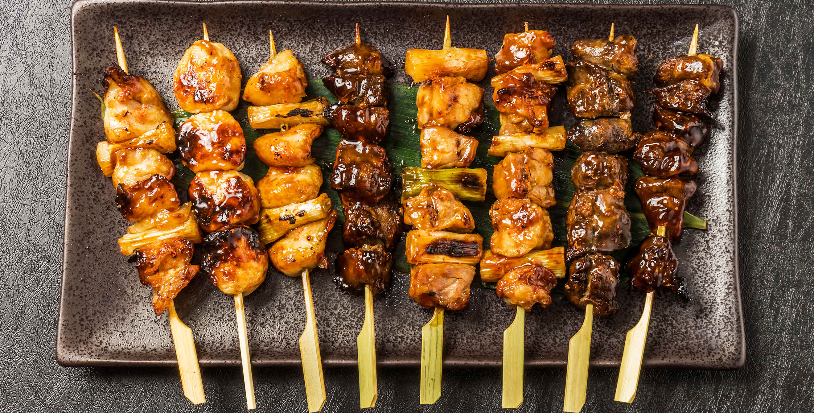 Plate of izakaya grilled meat skewers, photo