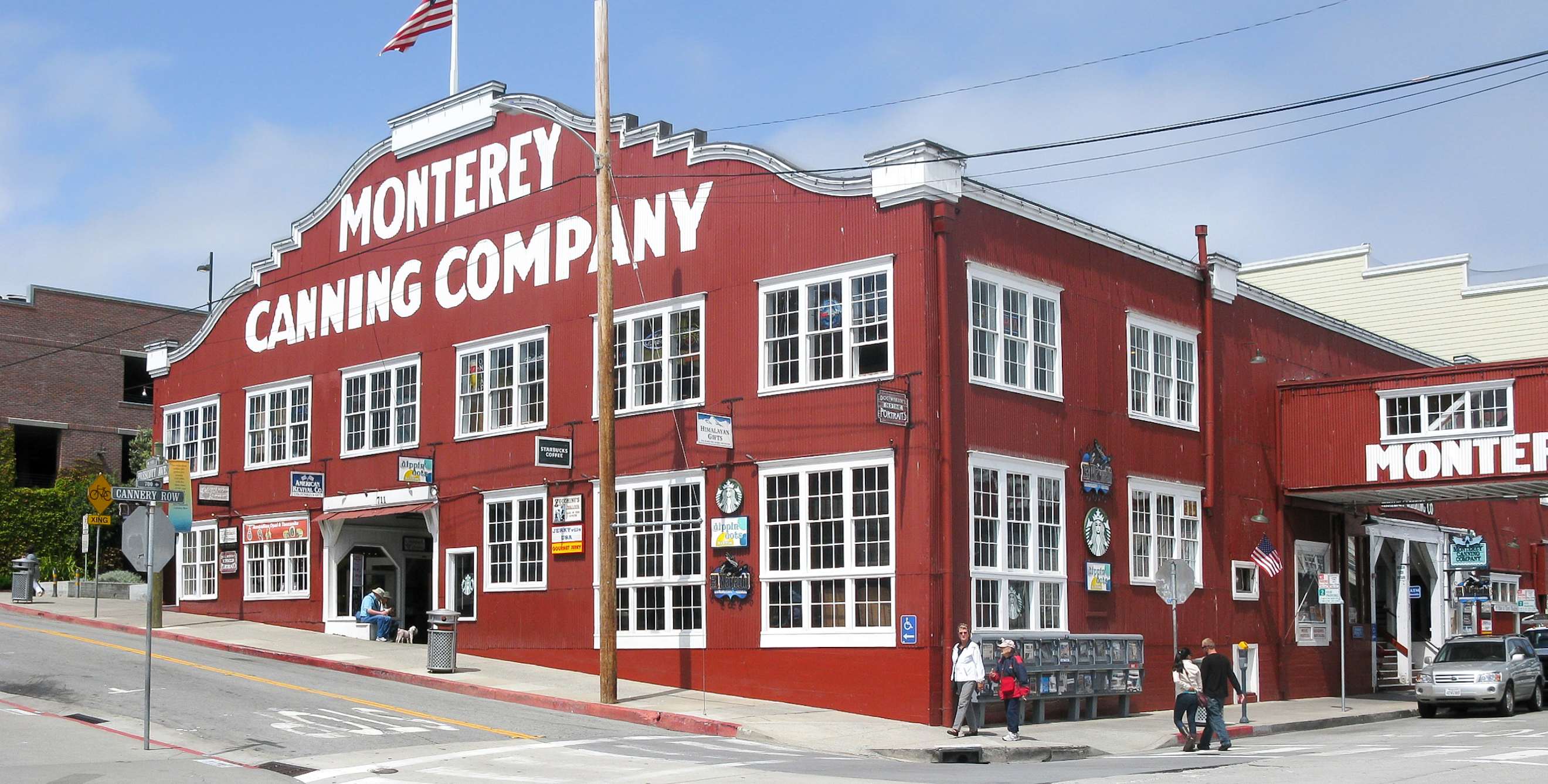 Monterey Canning Company's famed red facade with white trimmed multi-pane windows on Cannery Row in Monterey, California