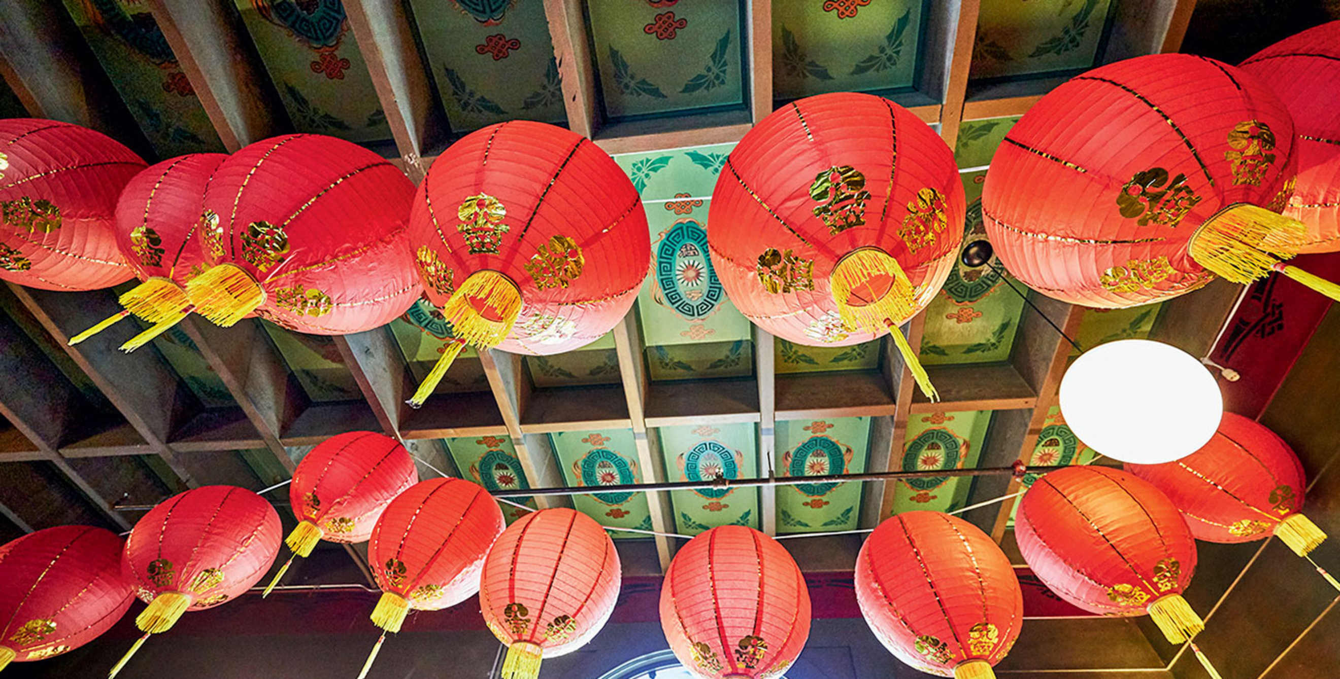 red lanterns hang beneath the foyer's hand-painted ceiling at the Chinese Historical Society of America Museum in San Francisco