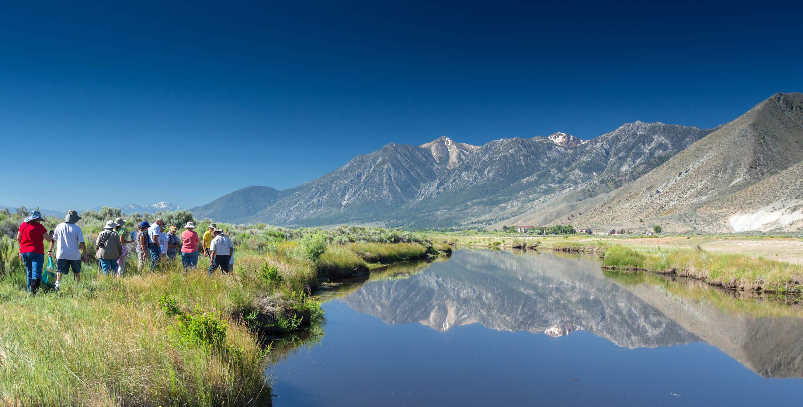 Group of people walking along a trail at the Nature Conservancy’s River Fork Ranch preserve in Nevada, photo