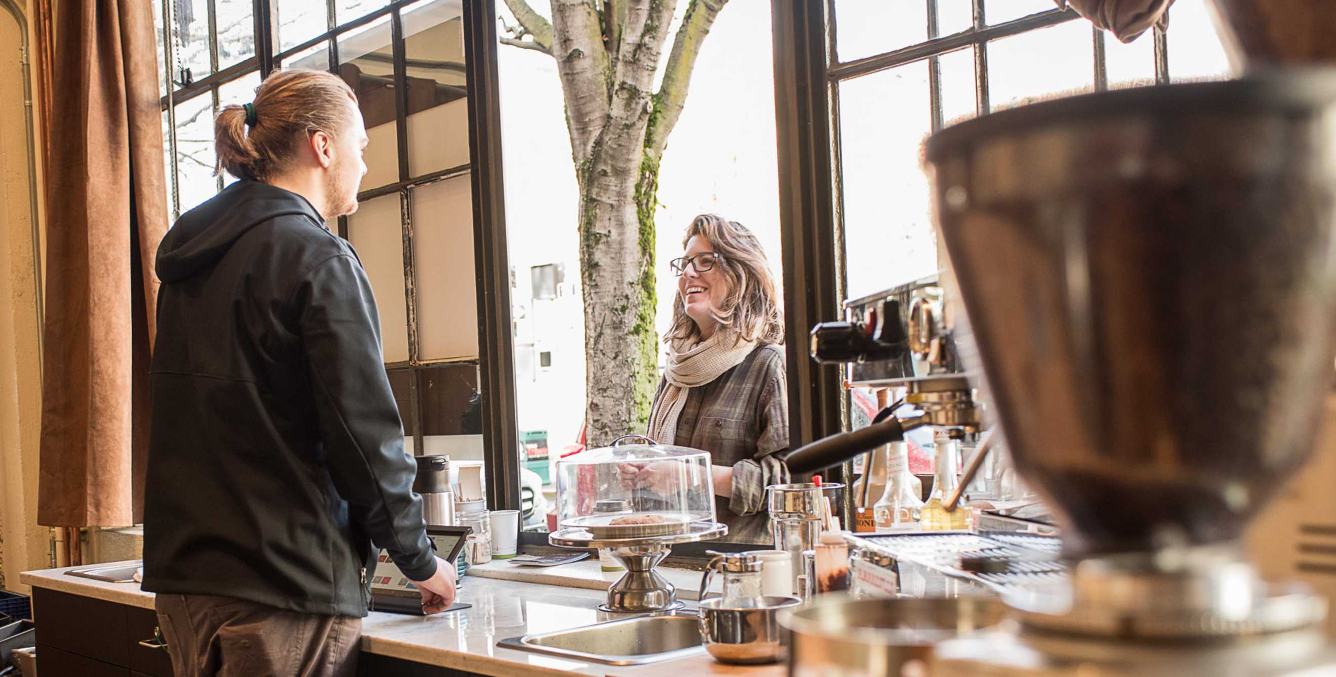 a barista helps a customer at Pear Barista in Portland, Oregon