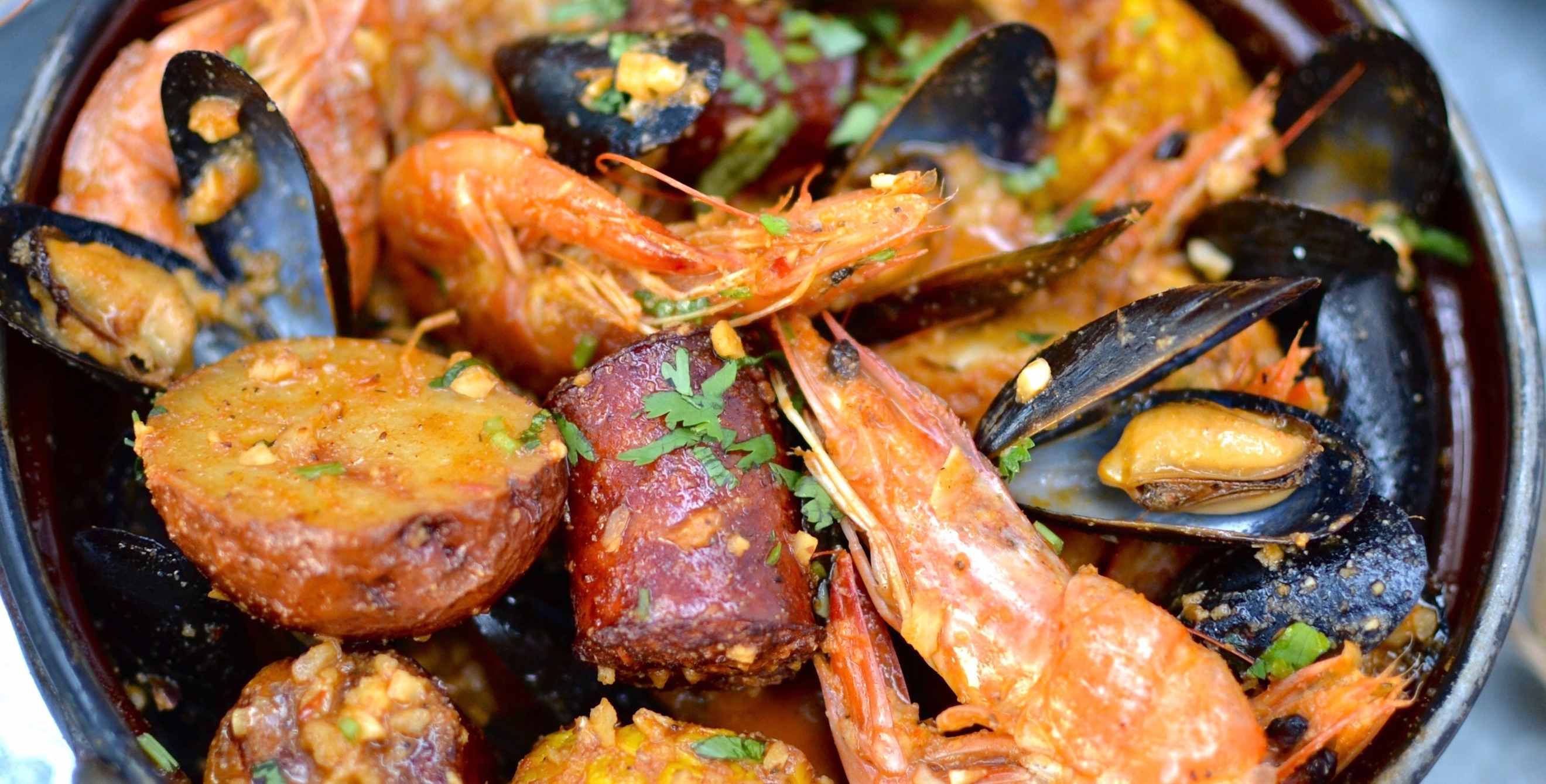 picture of the Cajun Crawl Combo with mussels, corn, potatoes, crawfish, and shrimp at alaMar in Oakland.
