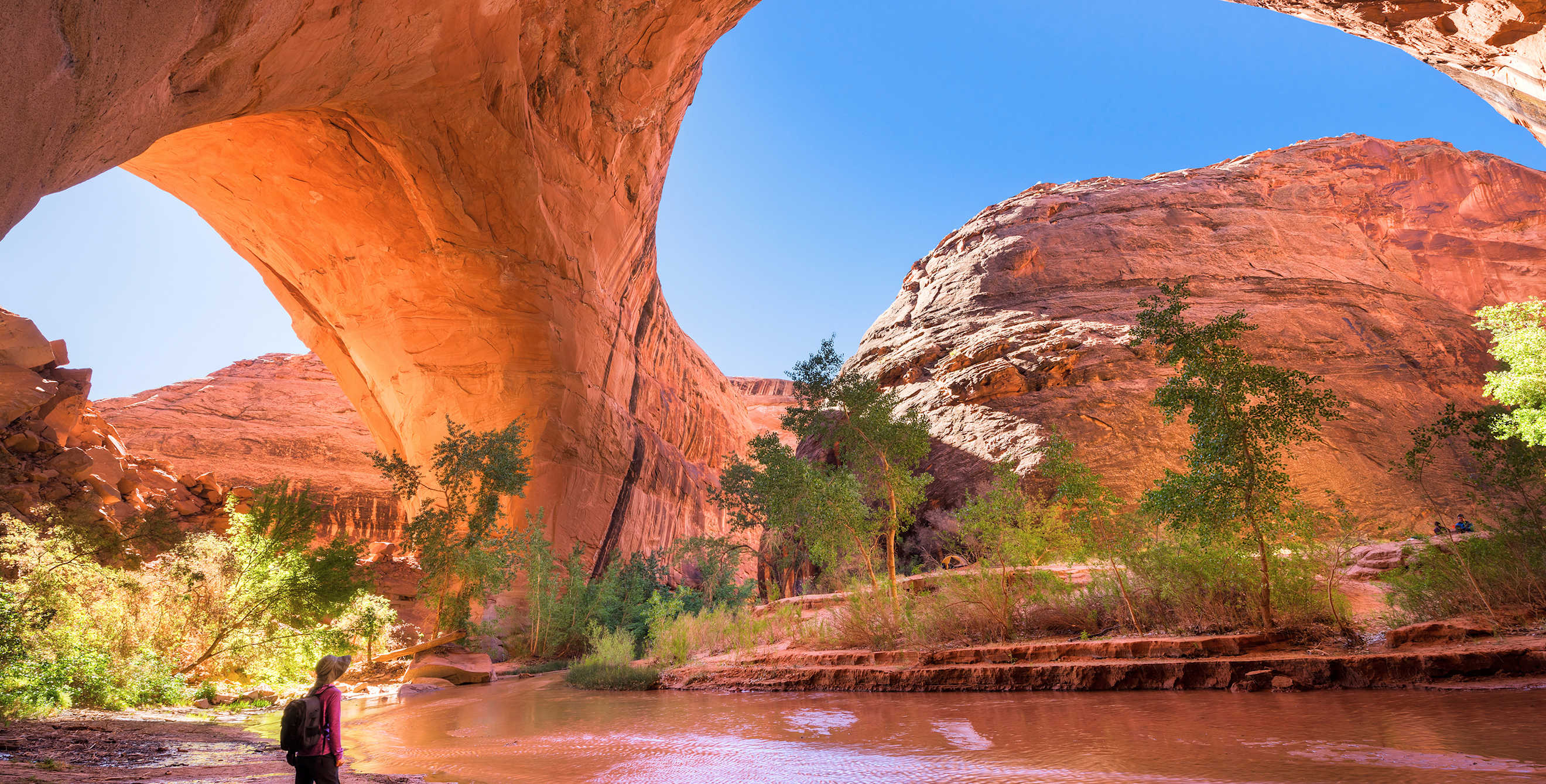 a hiker in Jacob Hamblin Arch in Grand Staircase-Escalante National Monument's Coyote Gulch, picture