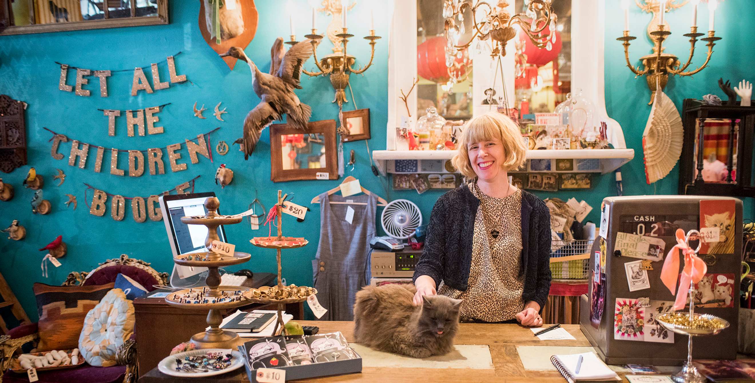 a clerk pets the store cat at curiosity-filled Flutter