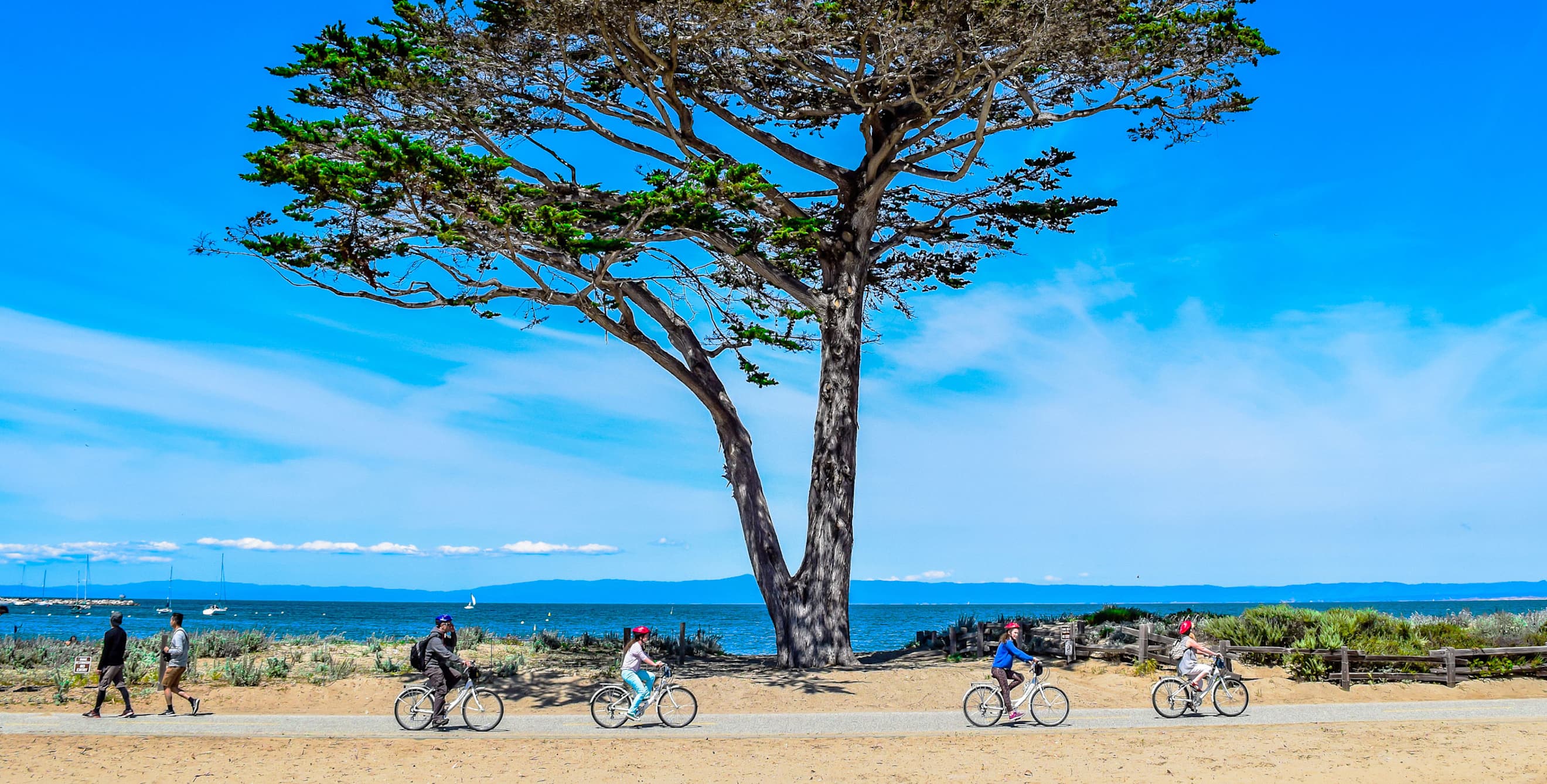 A family rides along the Monterey Bay Coastal Trail in Monterey, California, photo