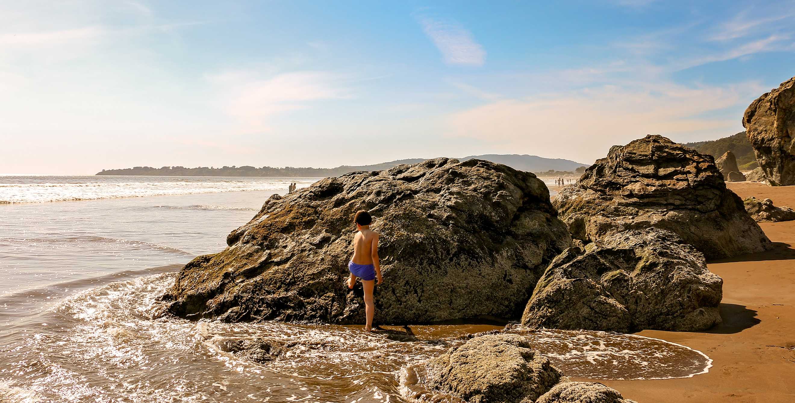 A child plays on the rocks at Stinson Beach in Marin County, California