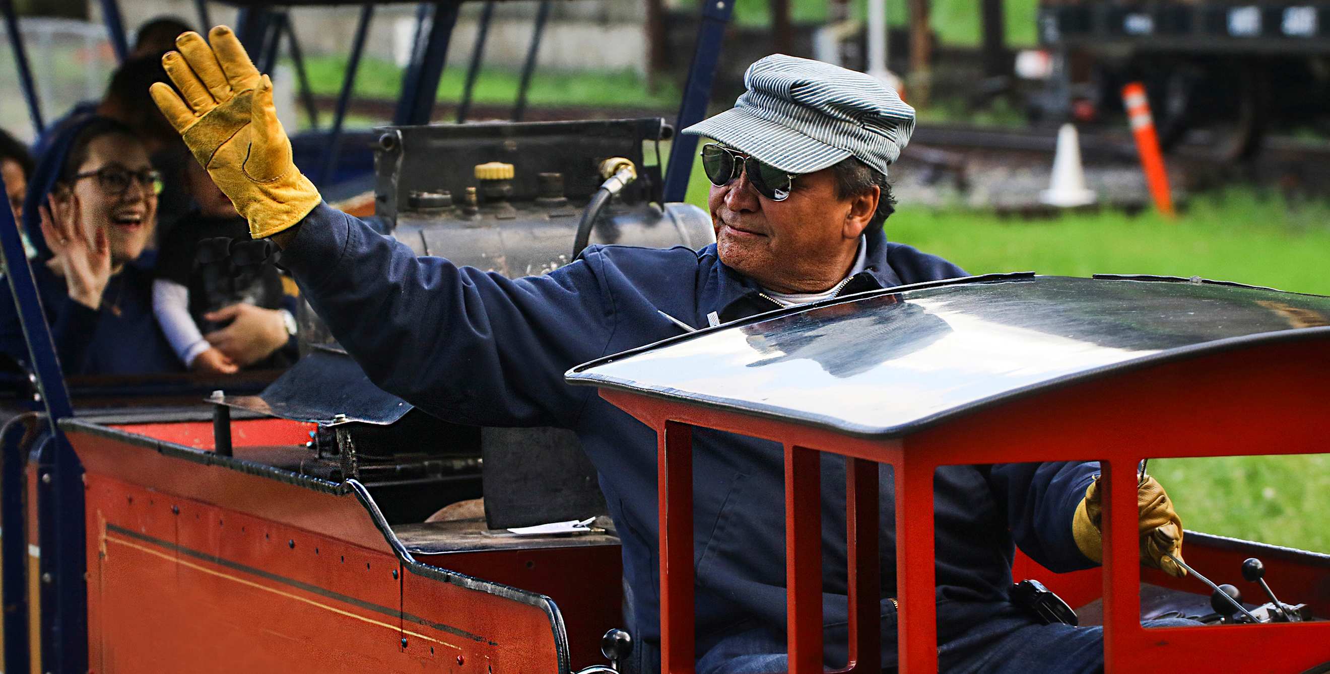 an engineer waves from the Griffith Park and Southern Railroad train