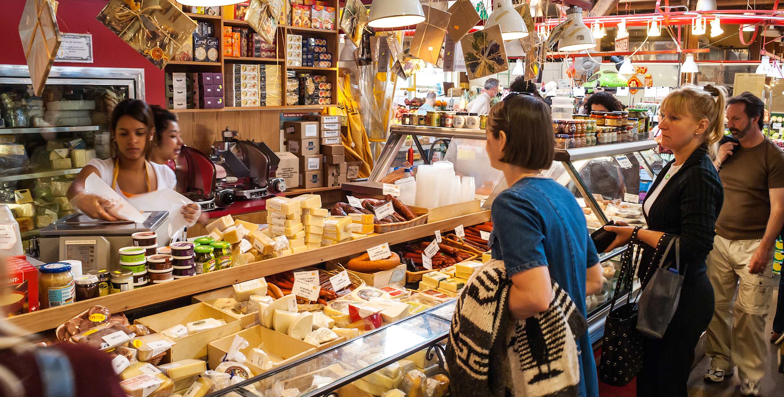 two women wait at the cheese counter in Granville Island's Public Market