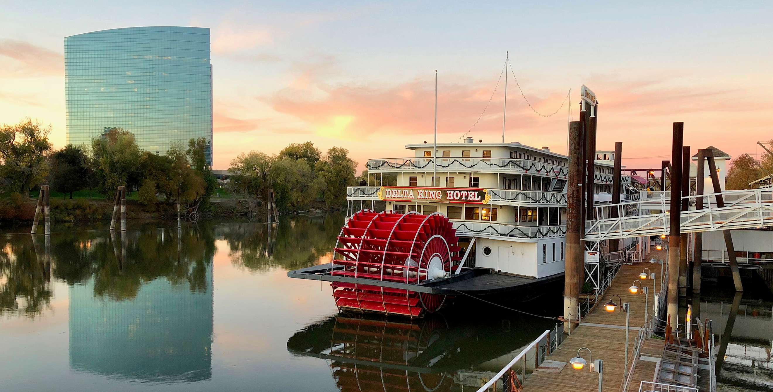 The Delta King riverboat cruises the Sacramento River at Sunset