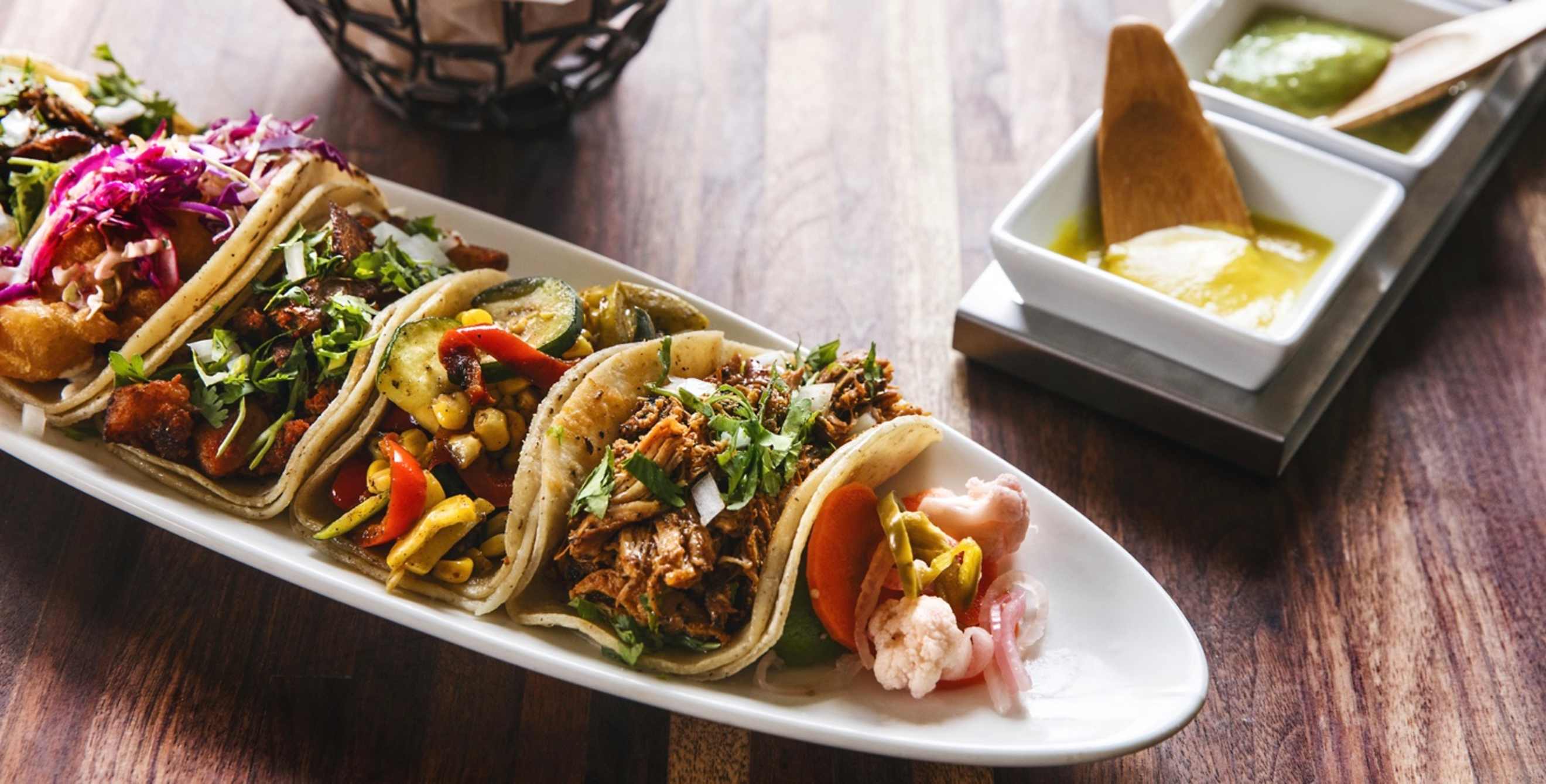 picture of a platter of tacos with salsa at Tacolicious in California