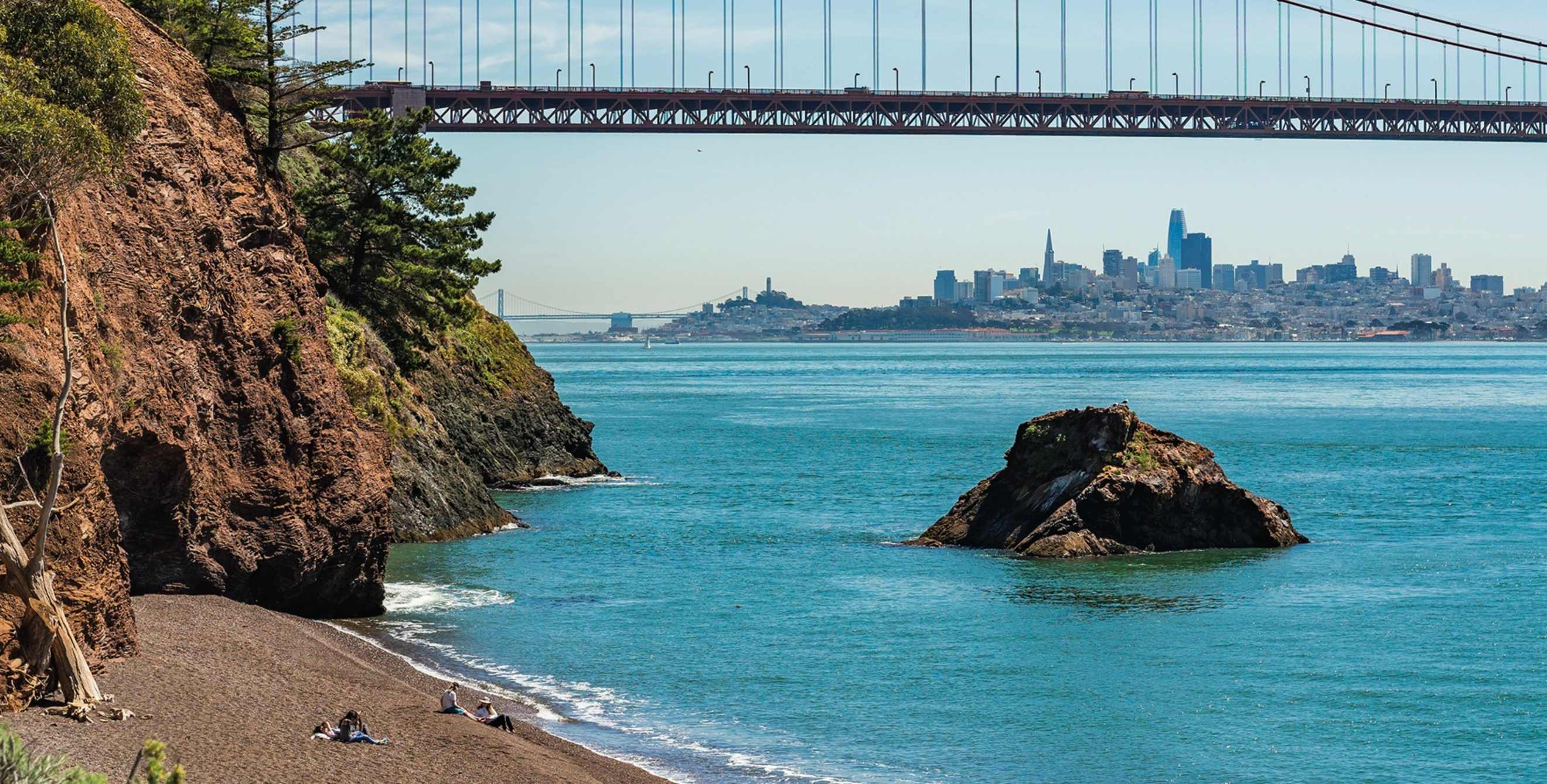 view from Kirby Cove towards the Golden Gate Bridge with San Francisco skyline on horizon, picture