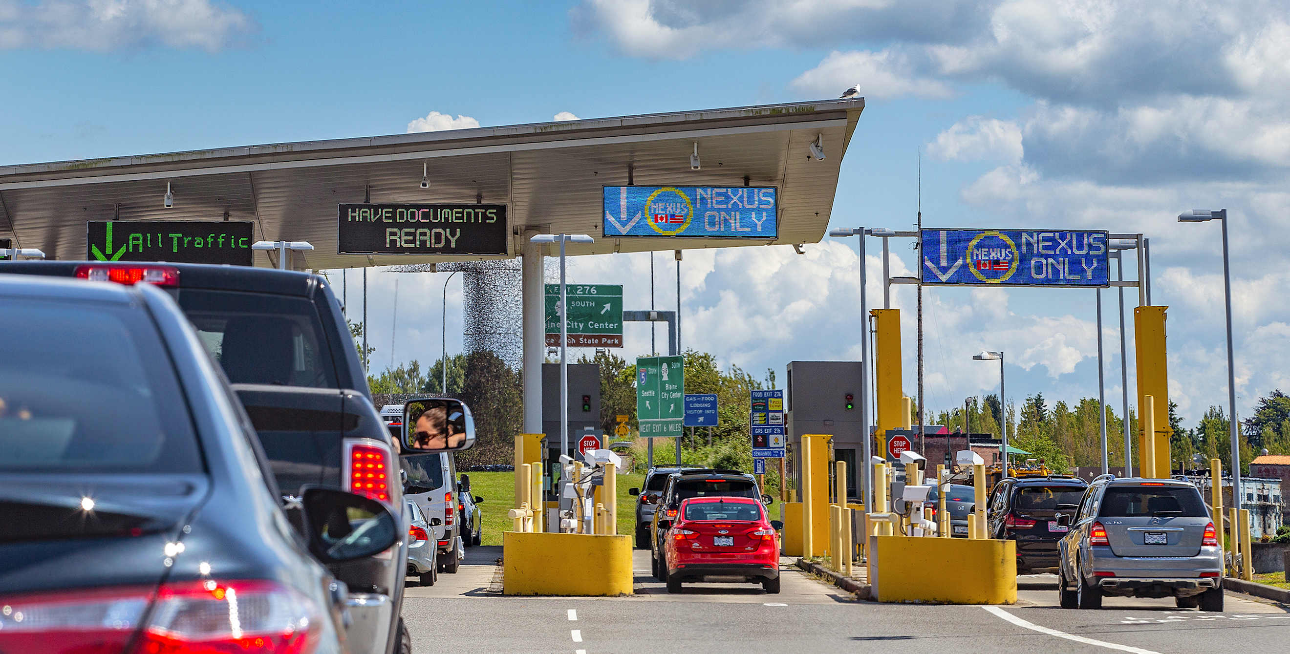 Cars wait in line at the U.S.-Canada border to drive into Canada