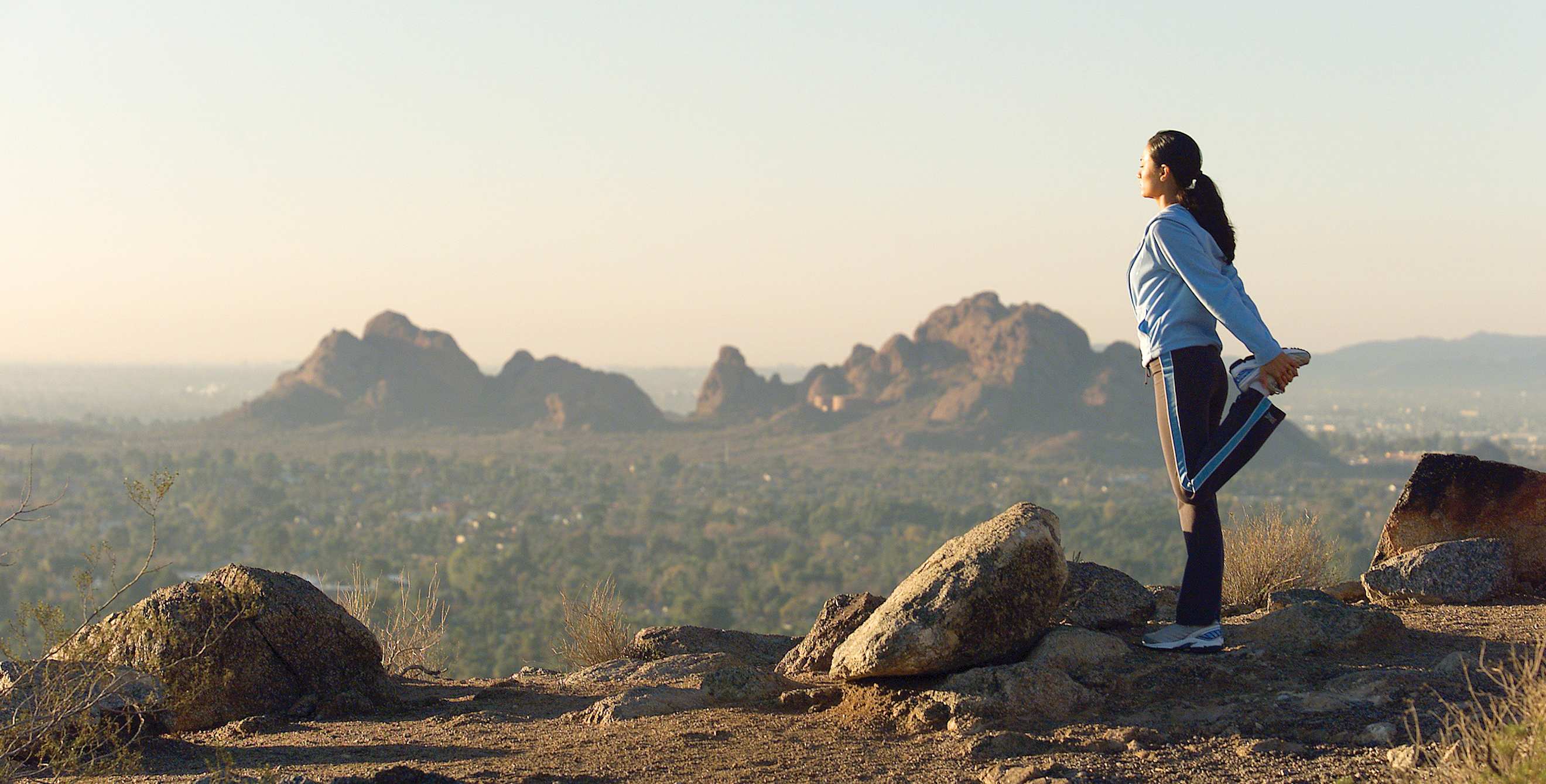 Woman stands atop Camelback Mountain in Paradise Valley, Arizona, image