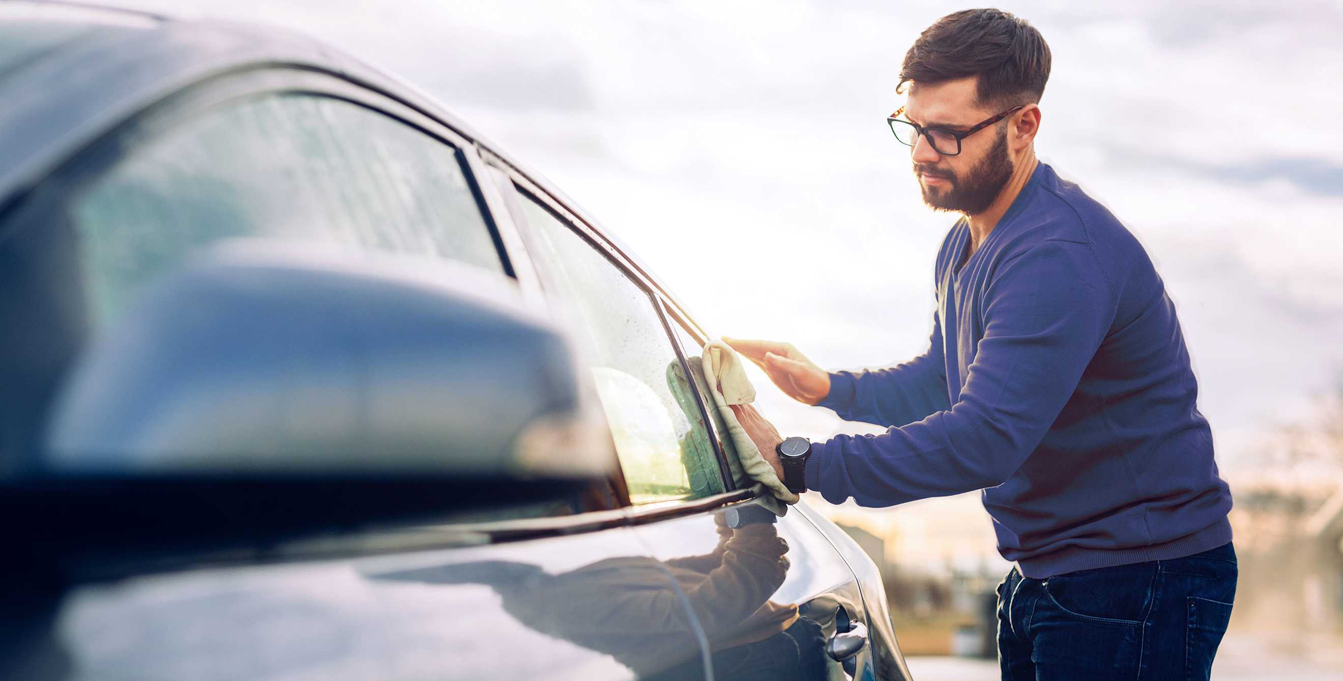a AAA Member cleans the windows on his car