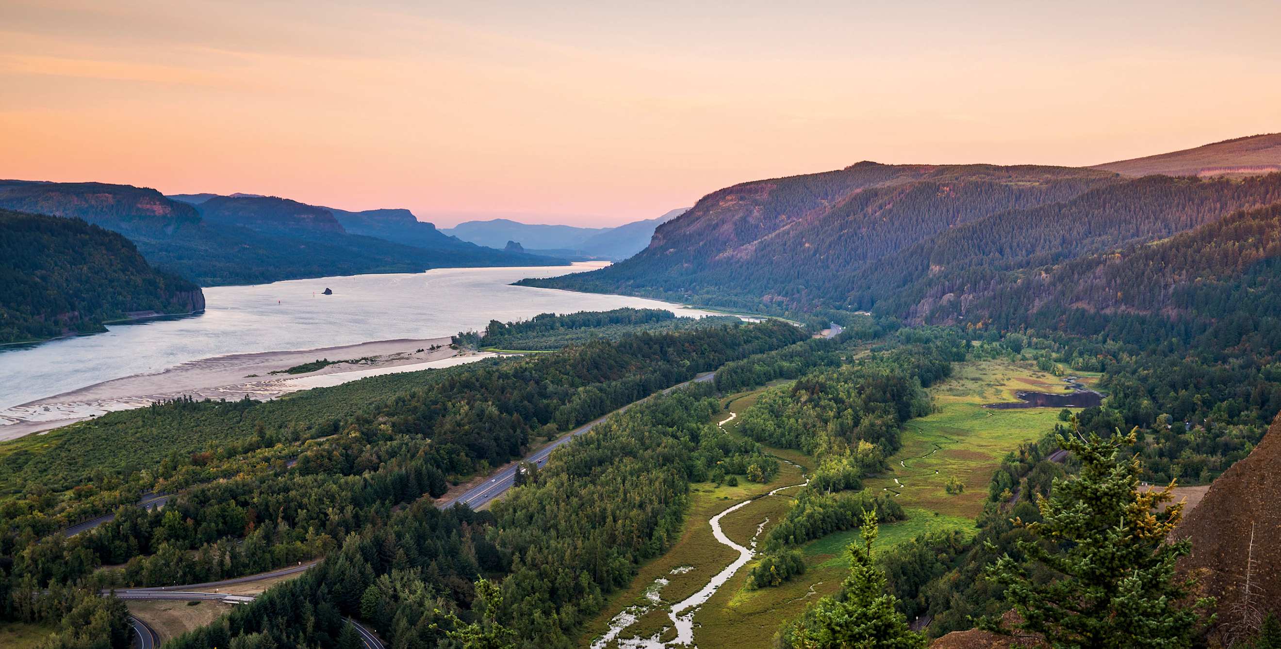 sunset panorama over Columbia River Gorge from the Crown Point Vista House in Multnomah County, Oregon