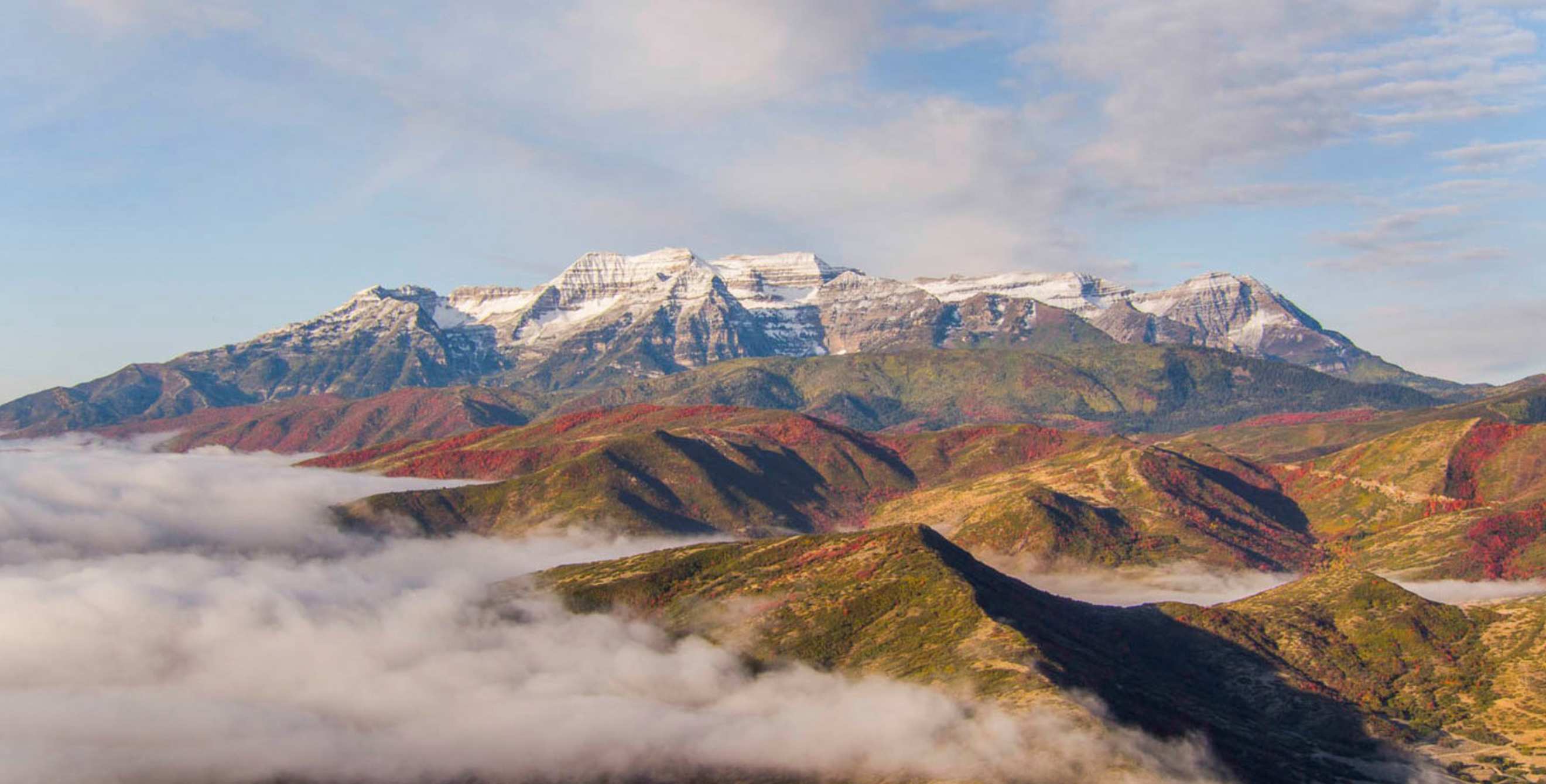 view of Utah's Wasatch Range, snow-capped in background, from Ray's Summit in autumn