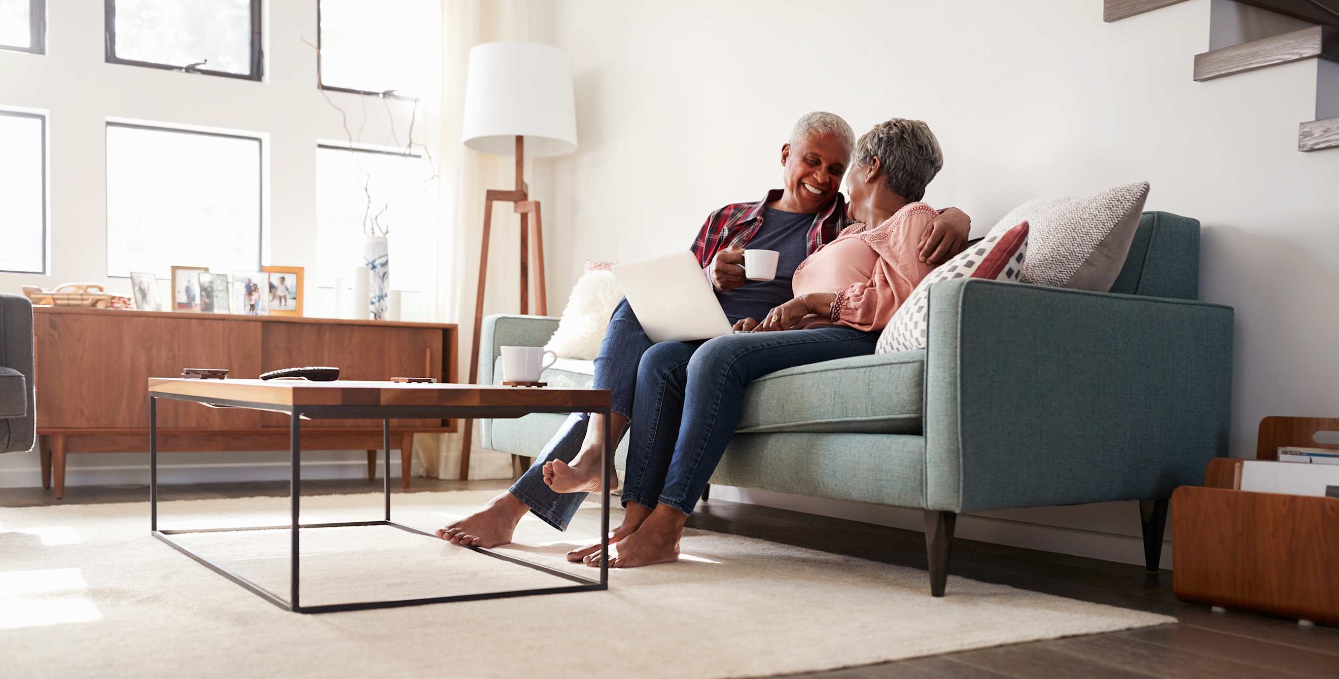 AAA Members review their credit scores on their couch.