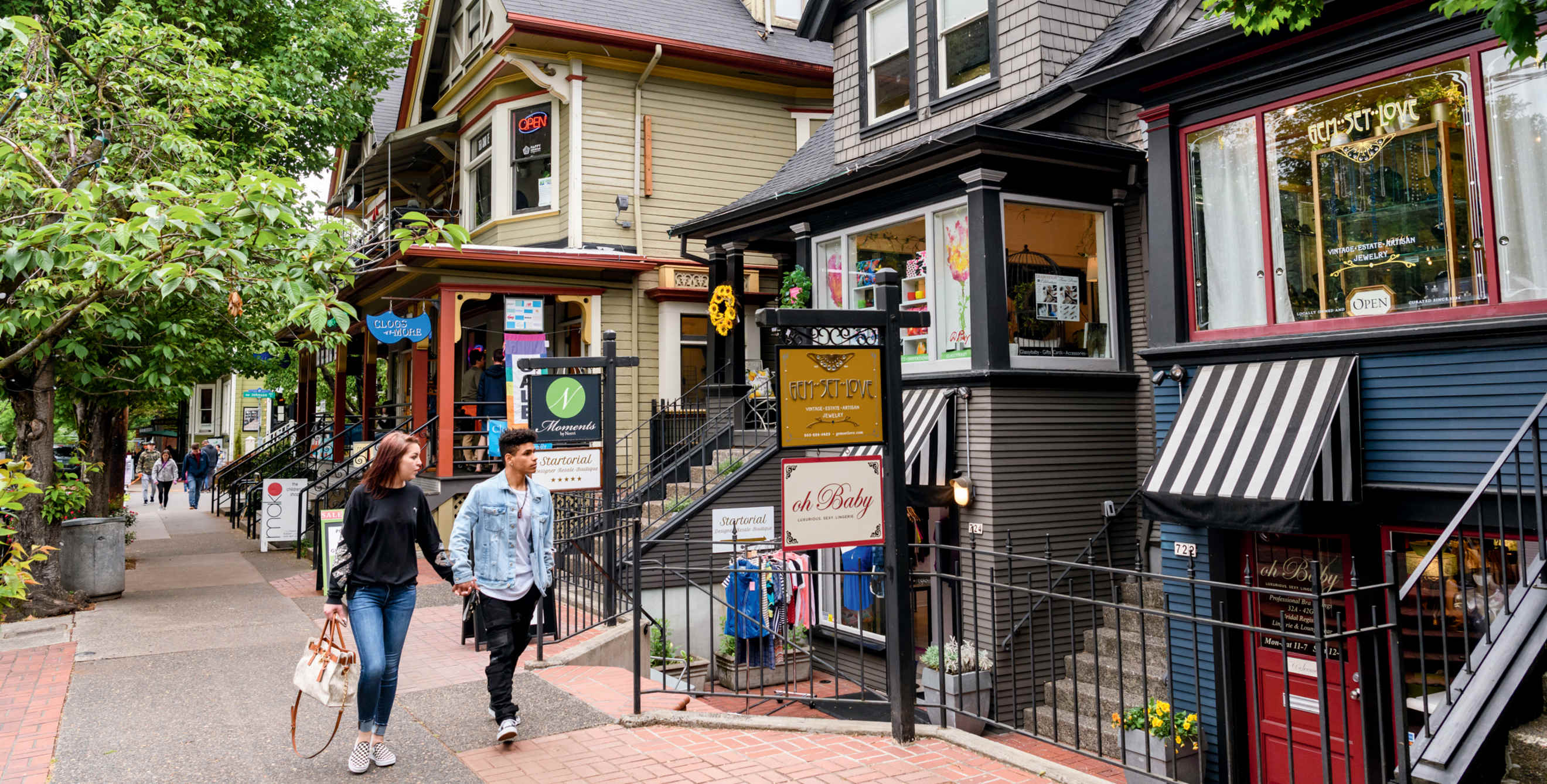 Window-shopping couple strolls along NW 23rd Avenue, in Portland, Oregon