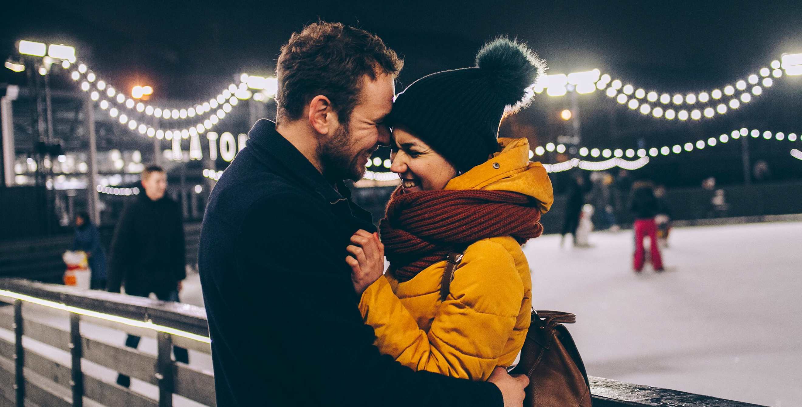 AAA Members outside of an outdoor skating rink in winter.