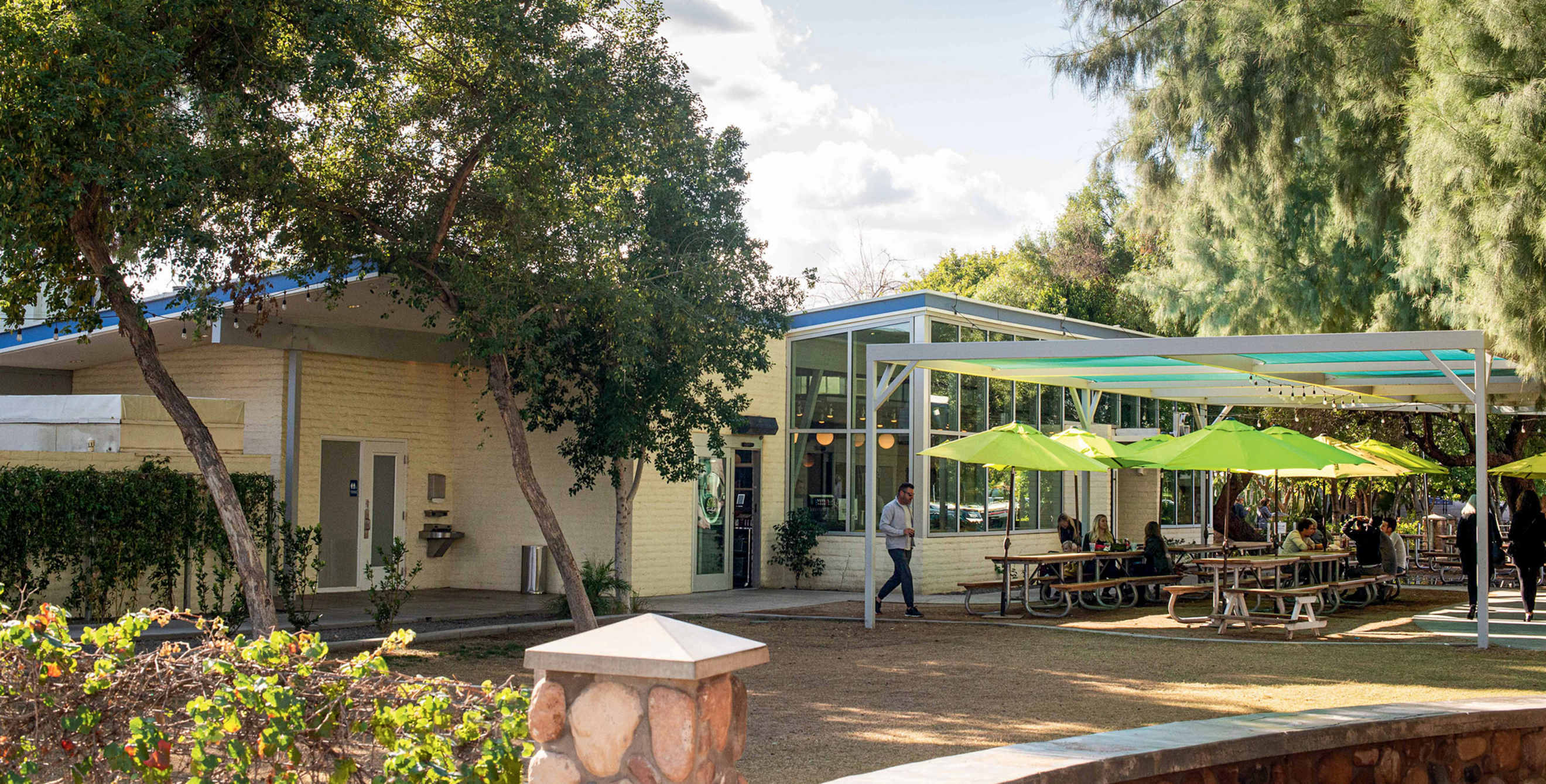 diners shaded by umbrellas on the patio at Joe’s Farm Grill in Gilbert, Arizona