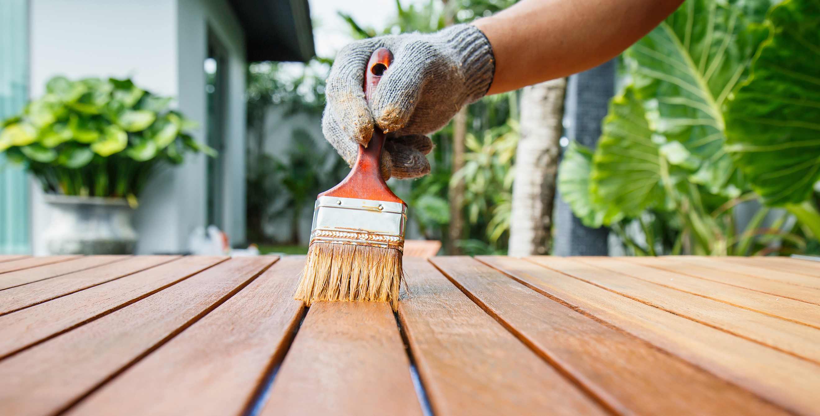 Homeowner staining a wood table