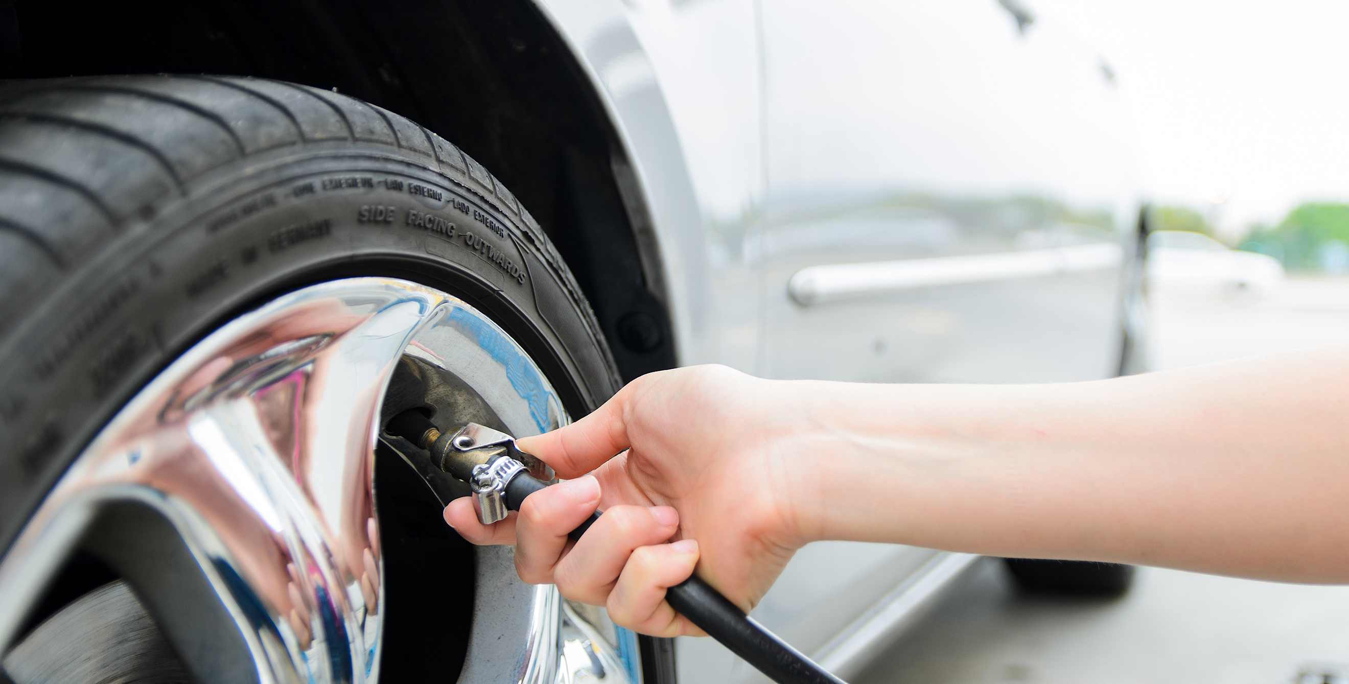 A driver fills front tire with air.