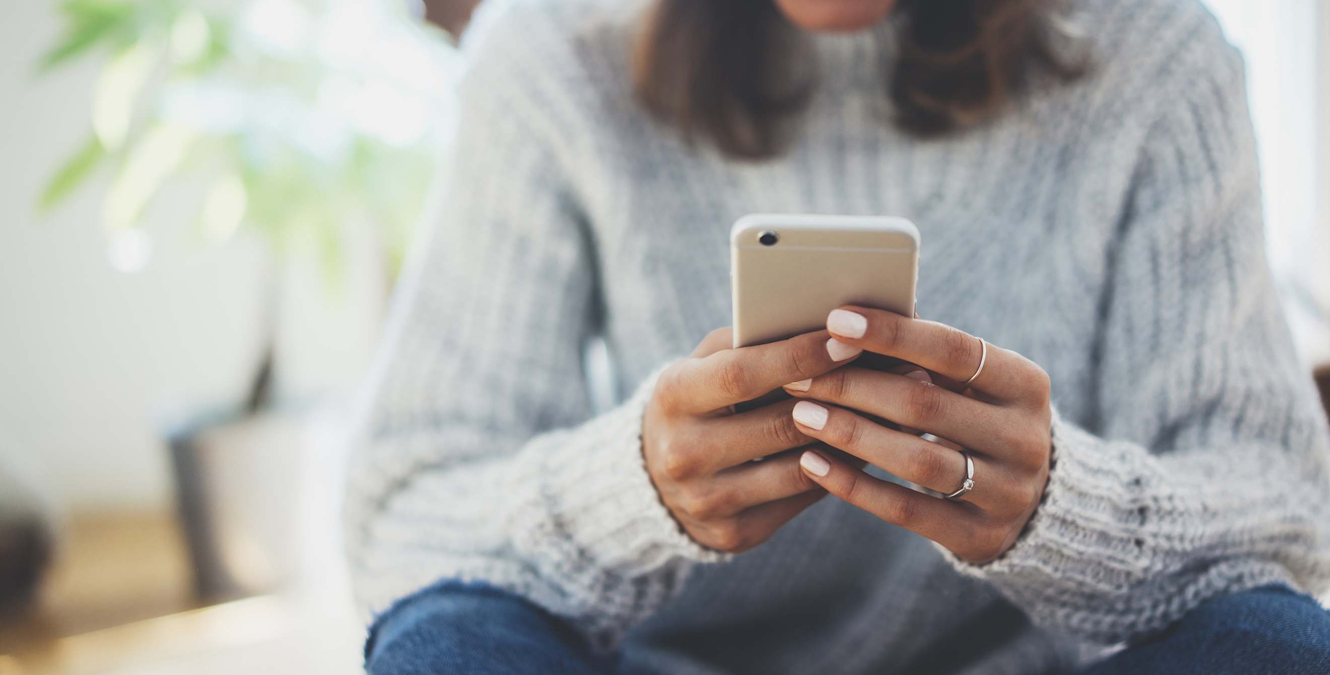 two hands holding an iphone.