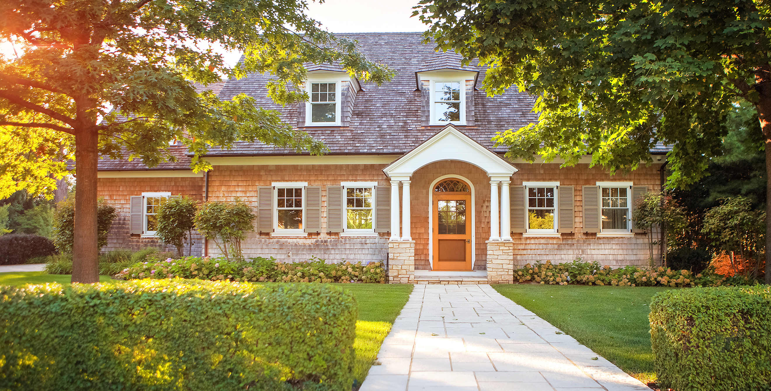A traditional two story home at sunset.