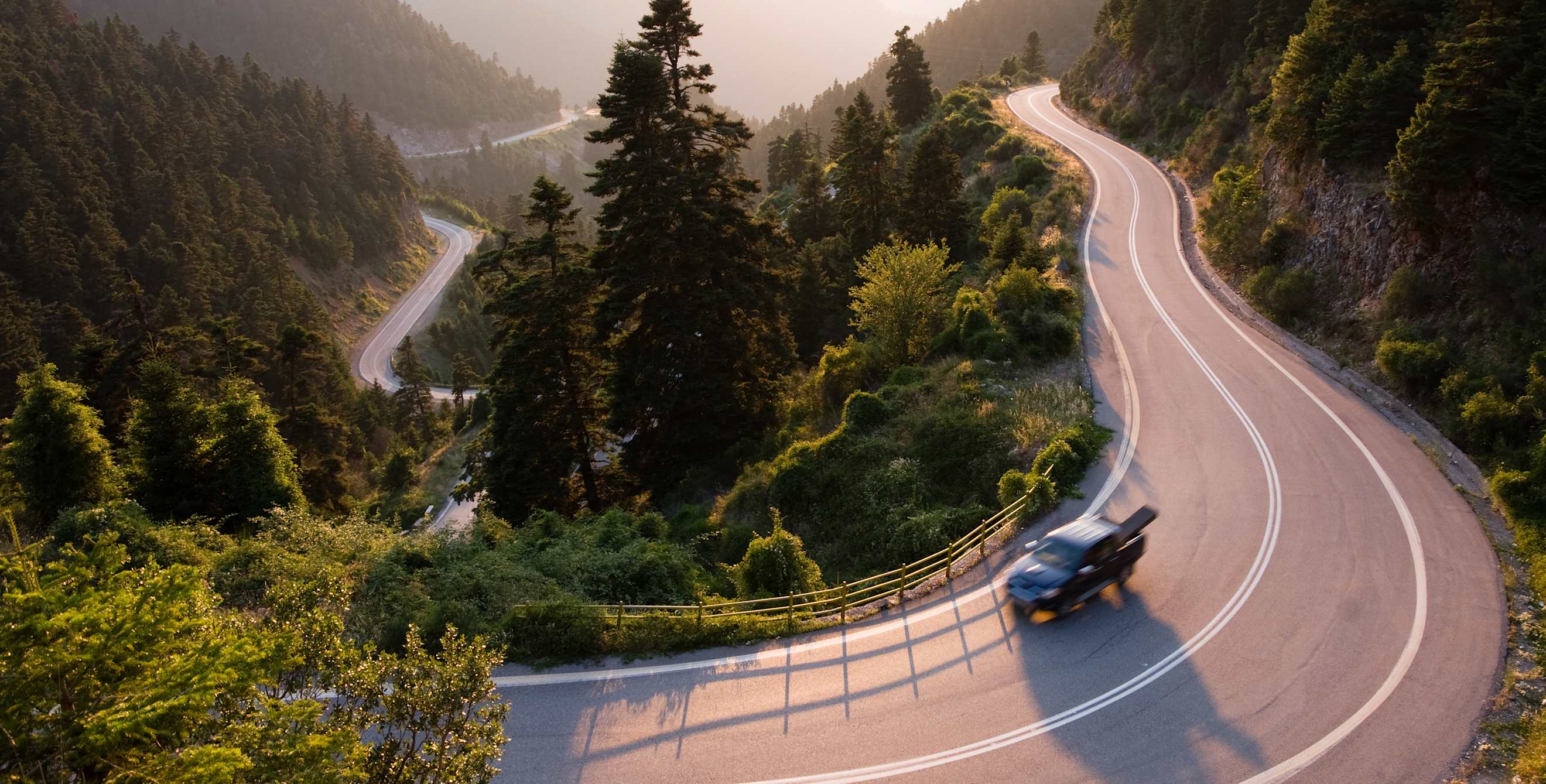 Truck on a winding mountain road.