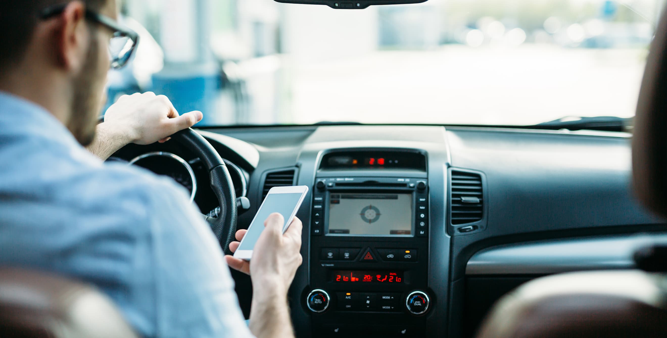 Driver texts behind the wheel.