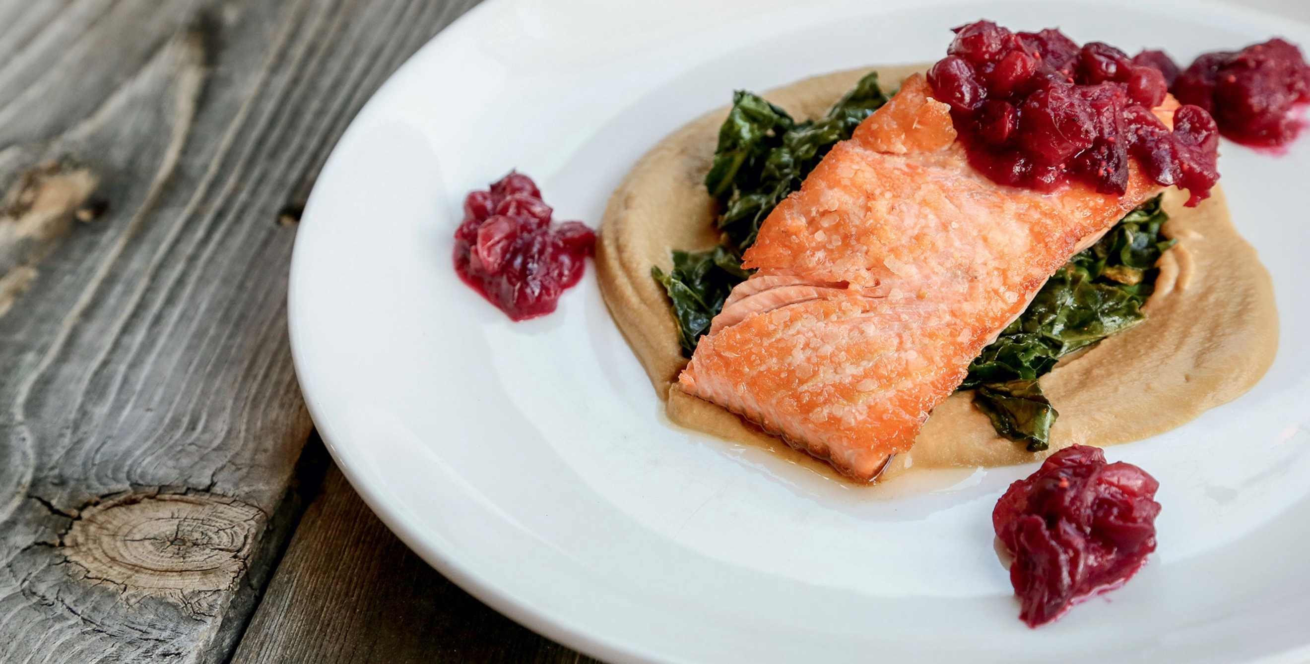 plate of pan-roasted salmon with cranberry compote, wilted greens on squash puree at Indian Pueblo Kitchen in the Pueblo Cultural Center, Albuquerque, New Mexico