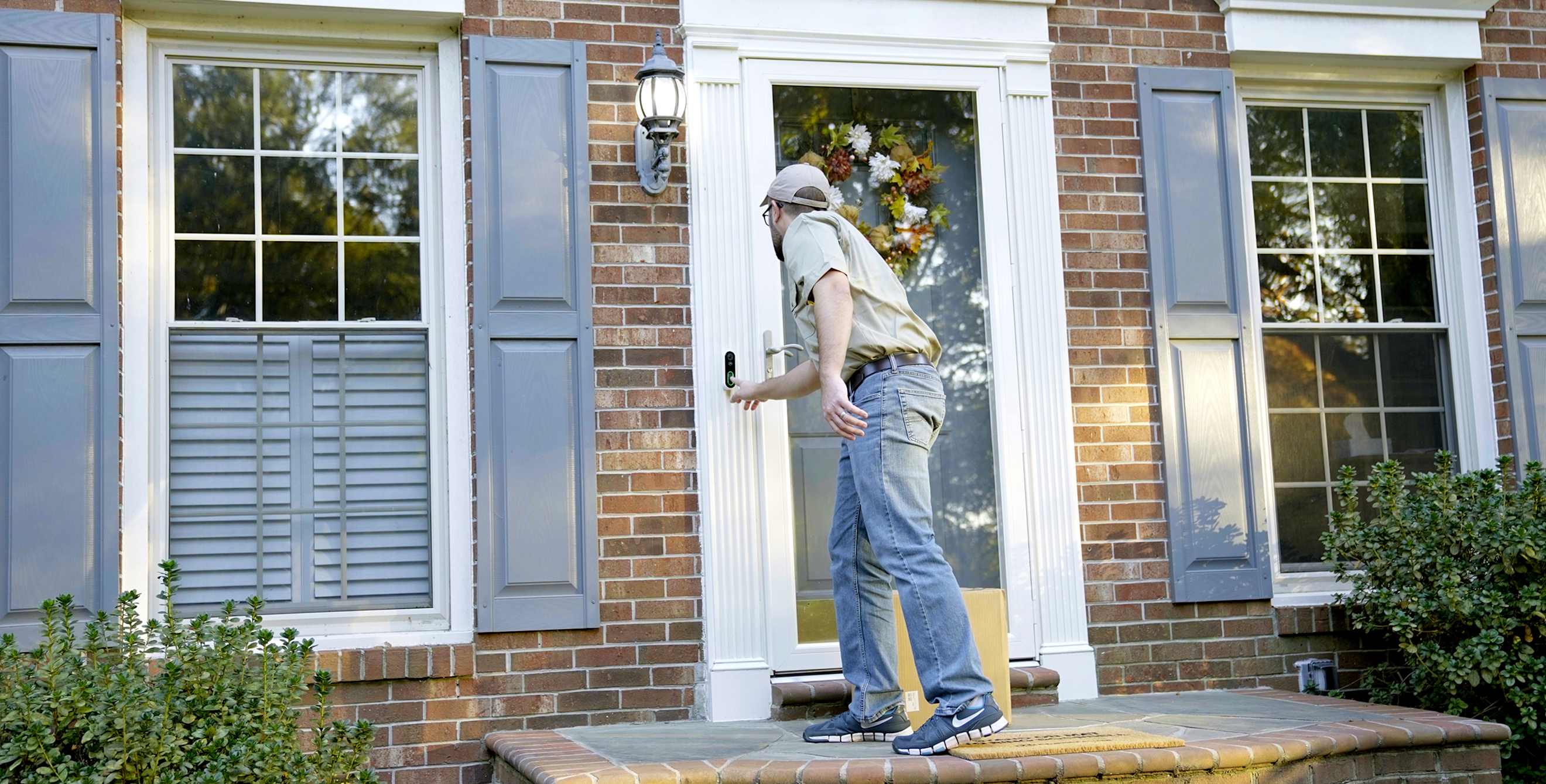 Delivery person rings smart video doorbell.