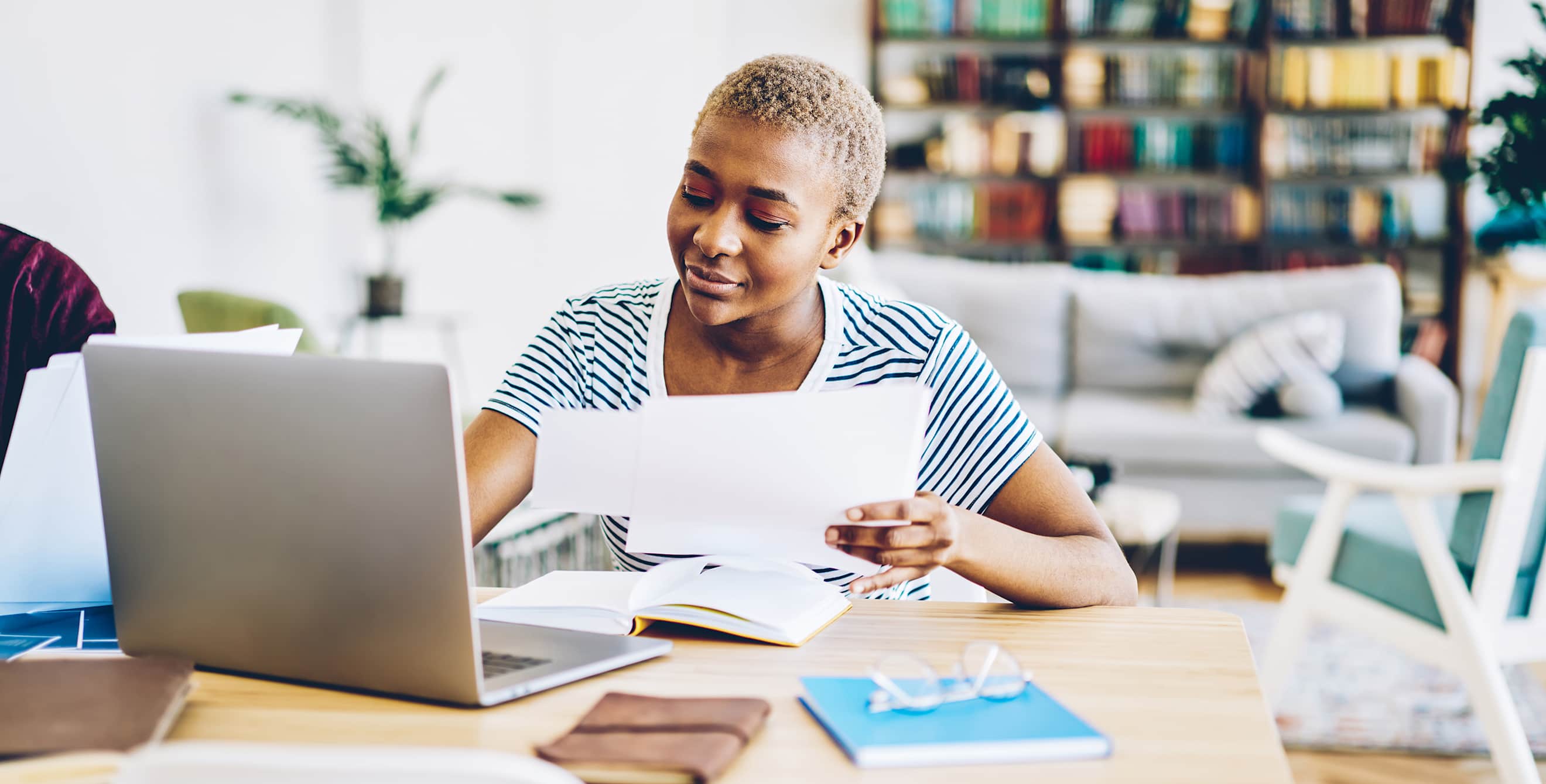 AAA Member does her taxes at the dining room table.